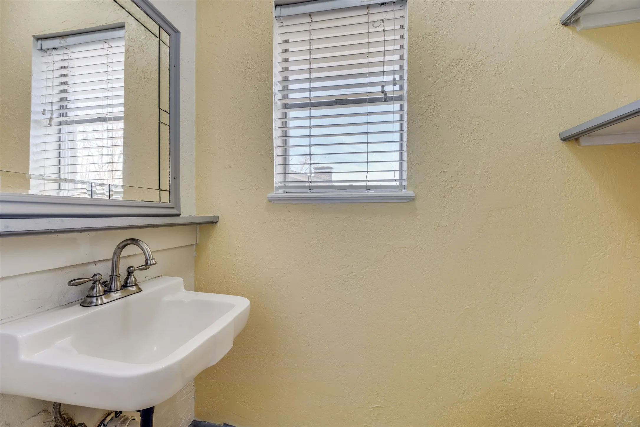 Guest bath is conveniently located  off the kitchen hallway.