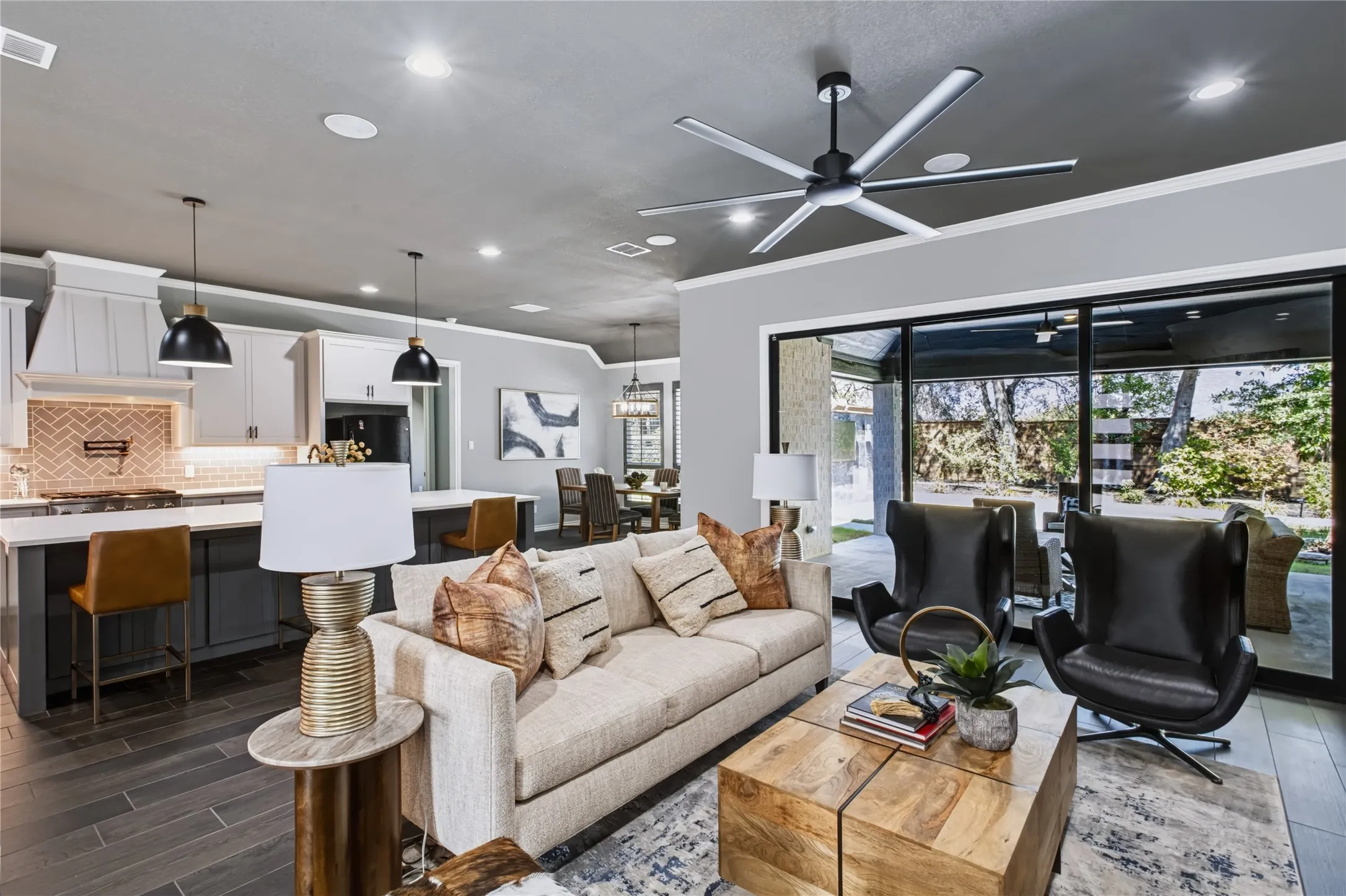 Open-concept living space featuring wood-finish flooring and a contemporary ceiling fan