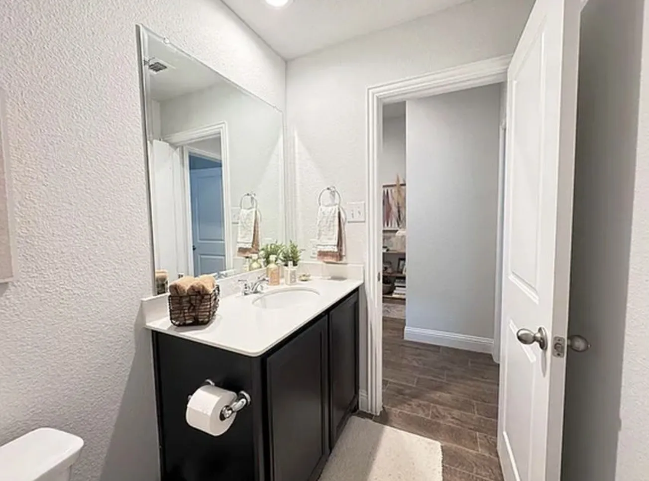 Vanity featuring a white countertop and dark cabinetry