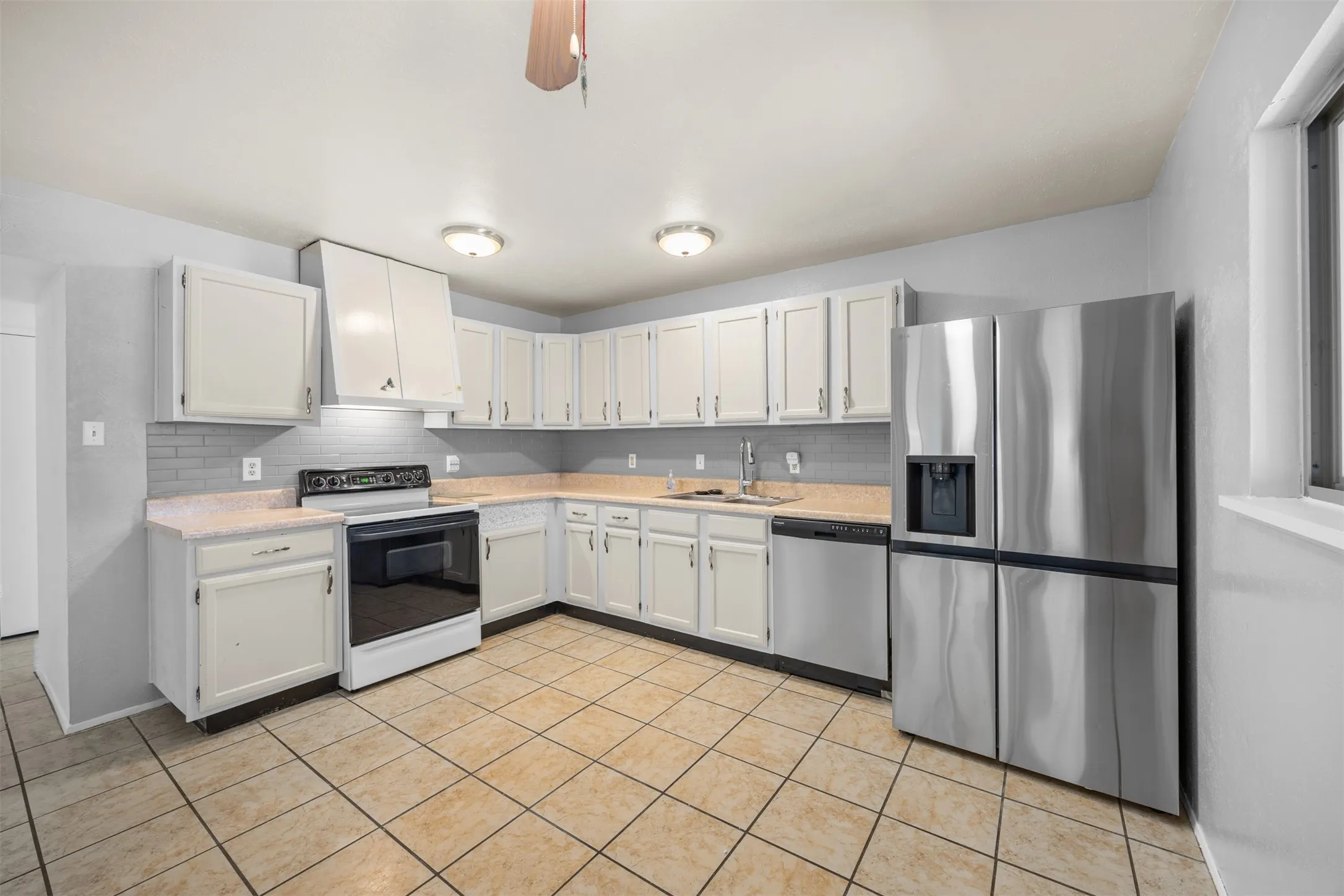 Open concept kitchen featuring a stainless steel LG refrigerator.