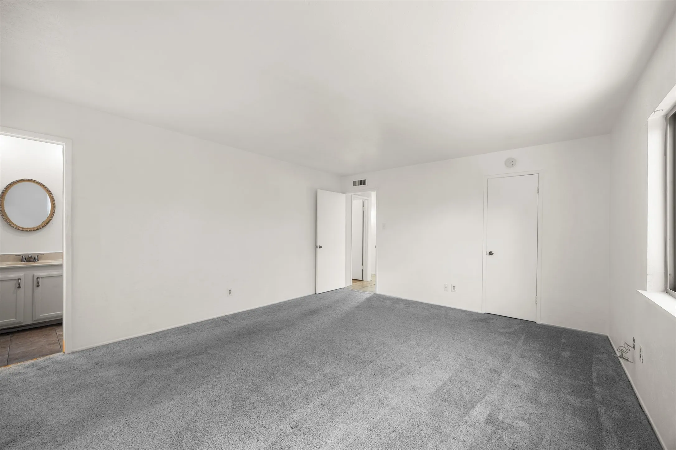 Spacious primary bedroom with walk in closet