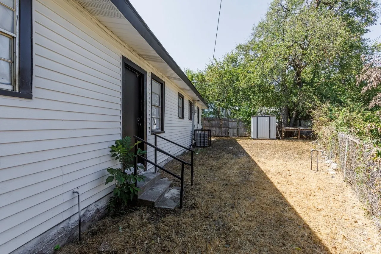Exterior siding with dark trim windows and door