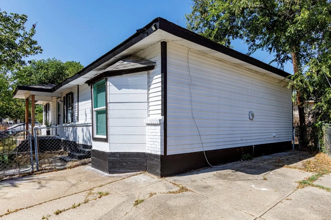 White horizontal siding exterior with dark trim
