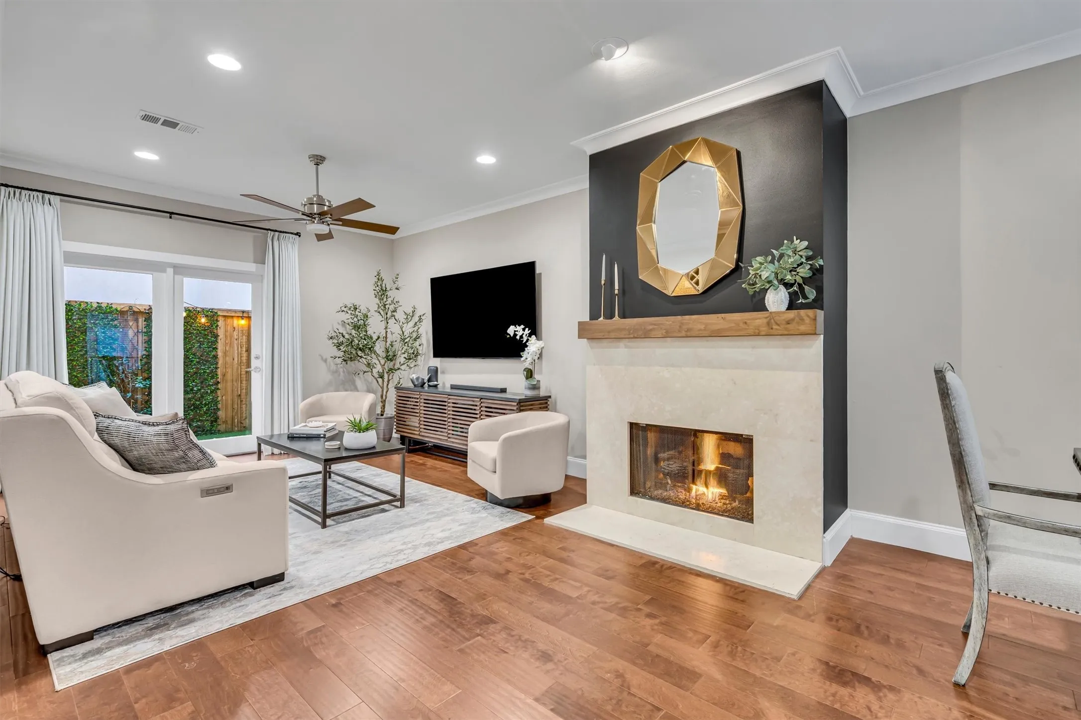 Wood-finish flooring throughout, recessed lighting, and a ceiling fan