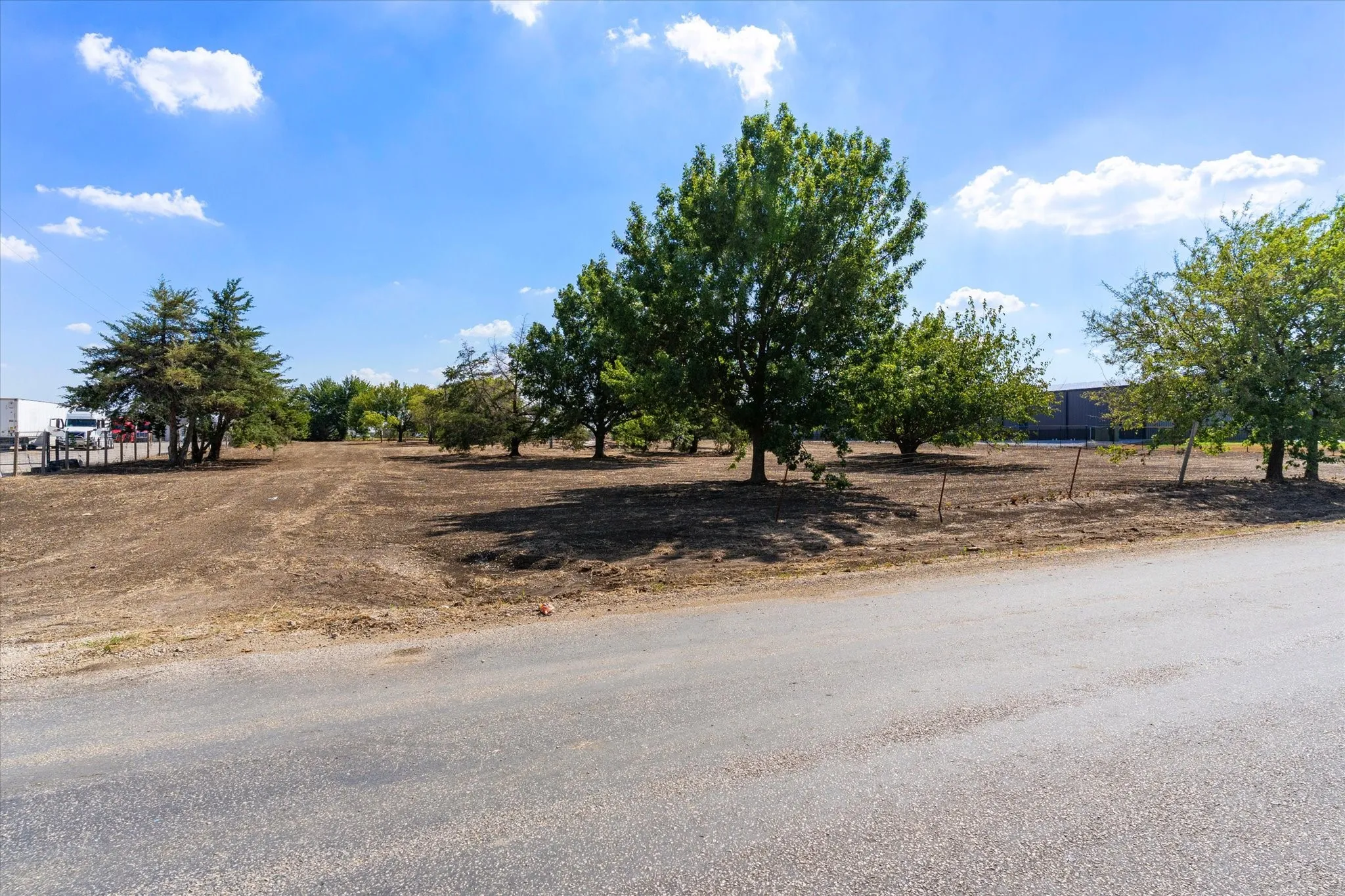 Expansive lot featuring mature trees and a clear, level terrain