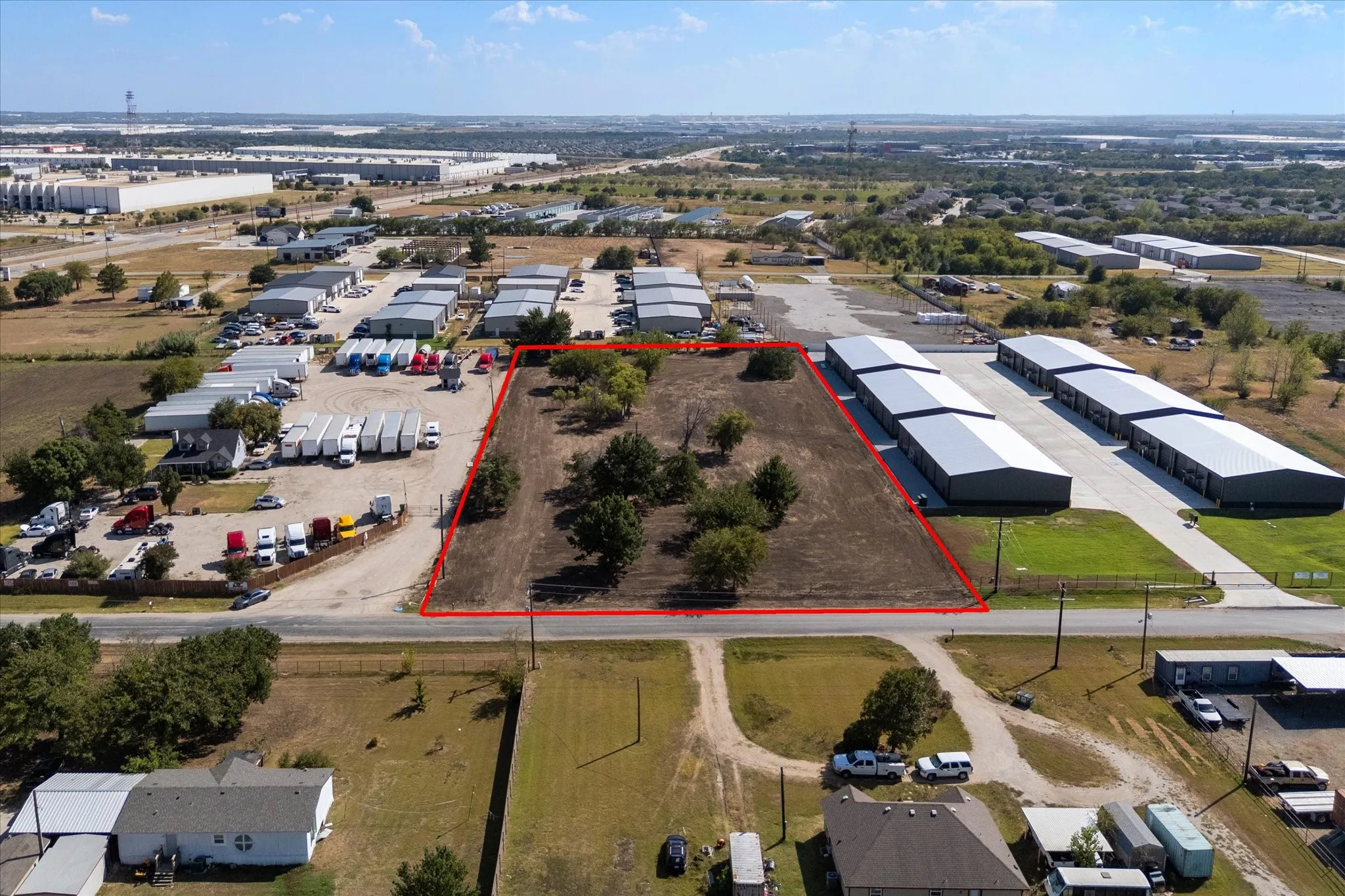 Expansive undeveloped lot featuring mature trees, a clear boundary, and direct road frontage