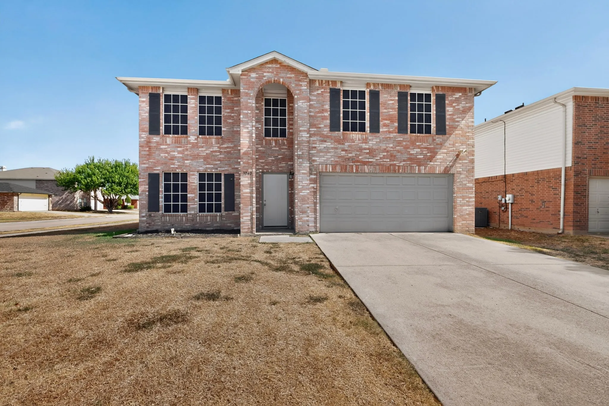 Brick facade with contrasting dark shutters