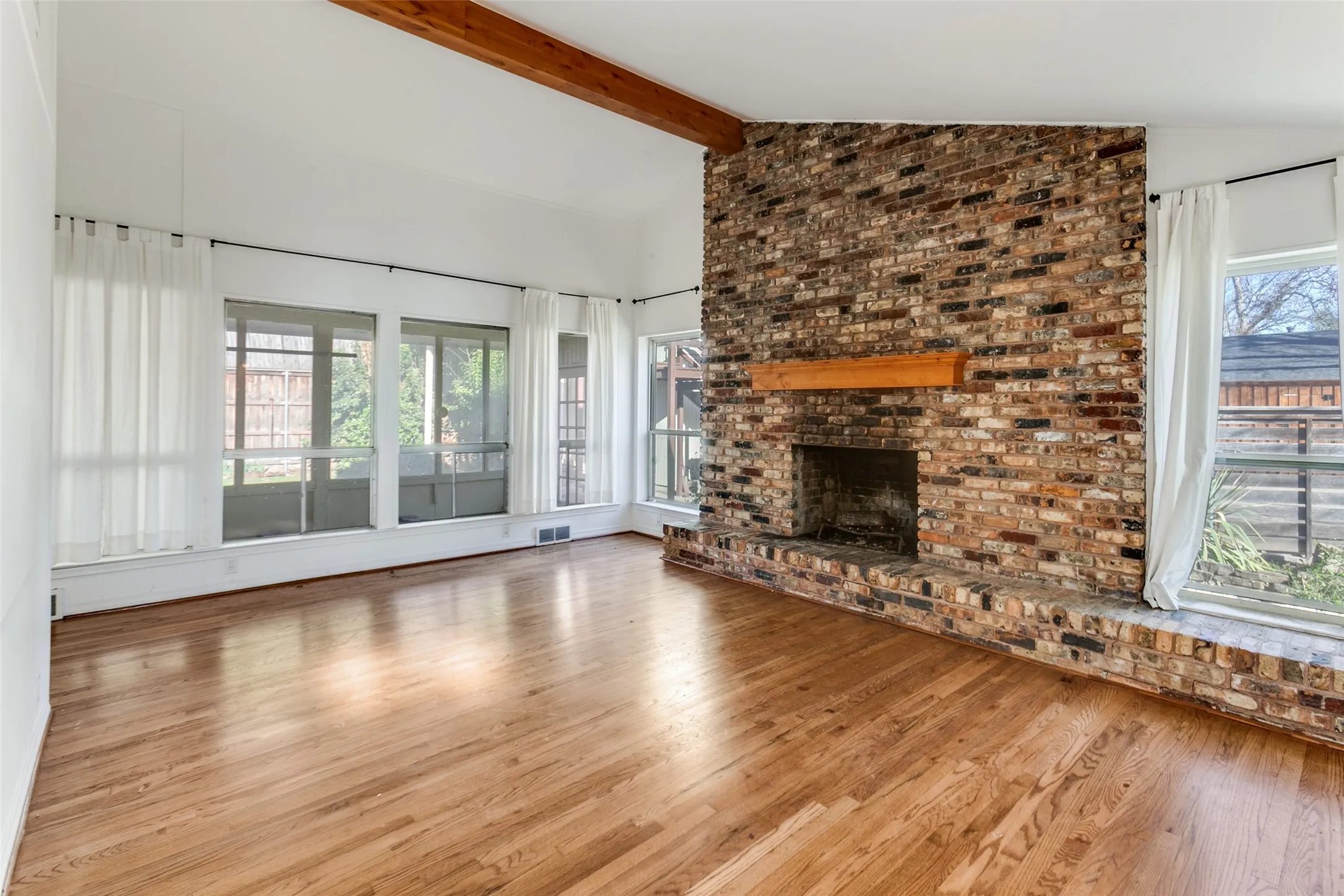 Gas FP; view through windows to sunroom. Beautiful hardwoods.