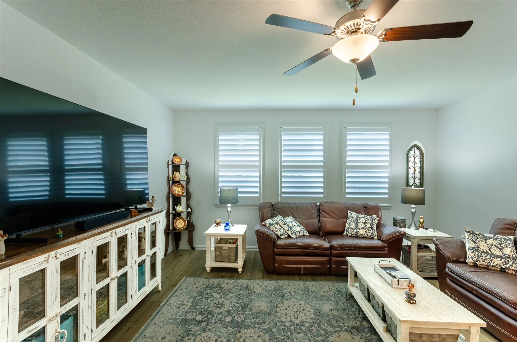 White walls featuring three windows with horizontal blinds