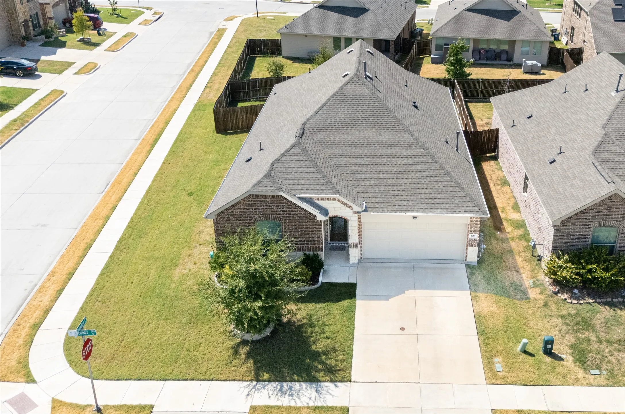 Brick and siding exterior with an attached garage, concrete driveway, and a shingle roof