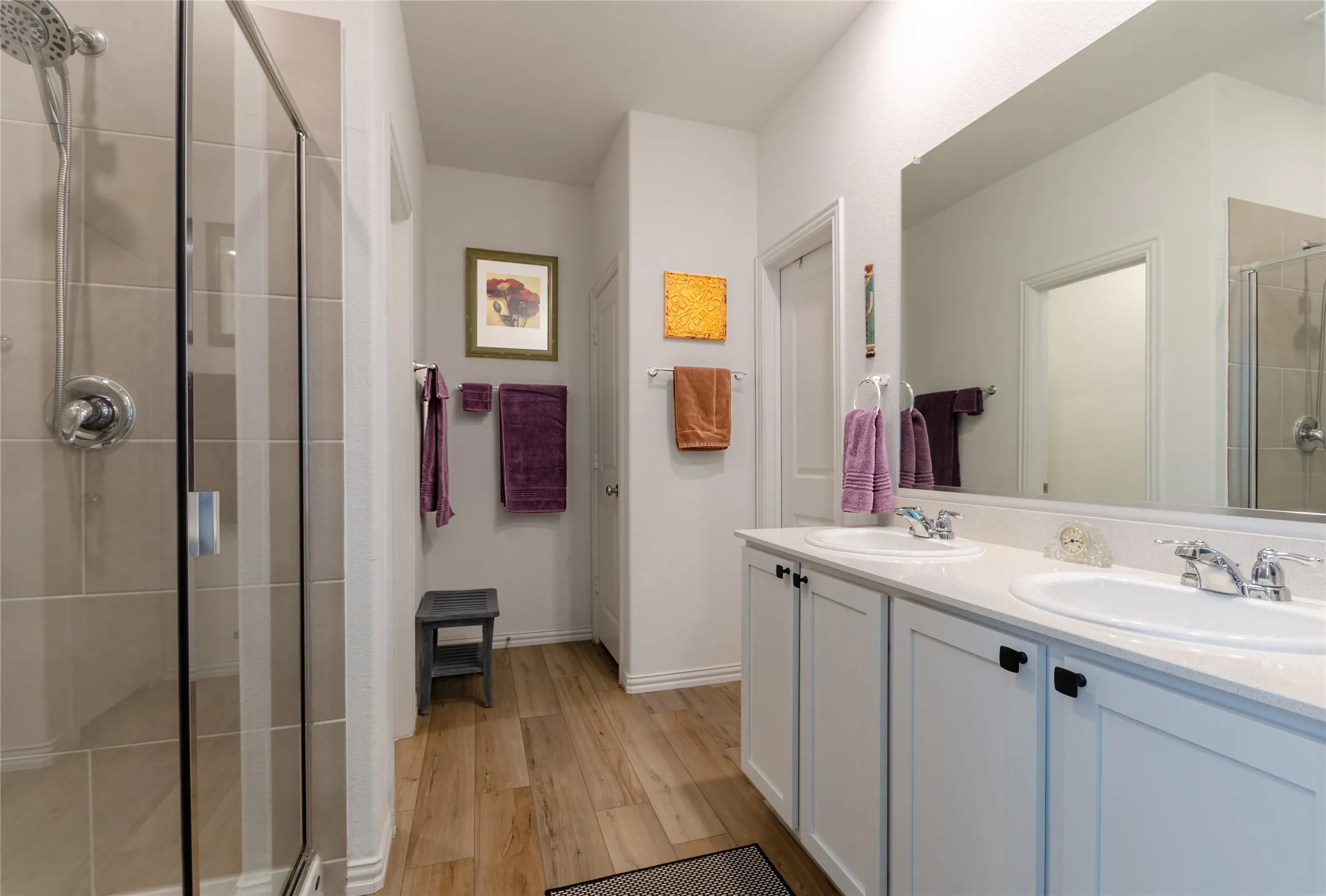 Recessed lighting with a ceiling fan, multiple windows with horizontal blinds, and wood-finish flooring