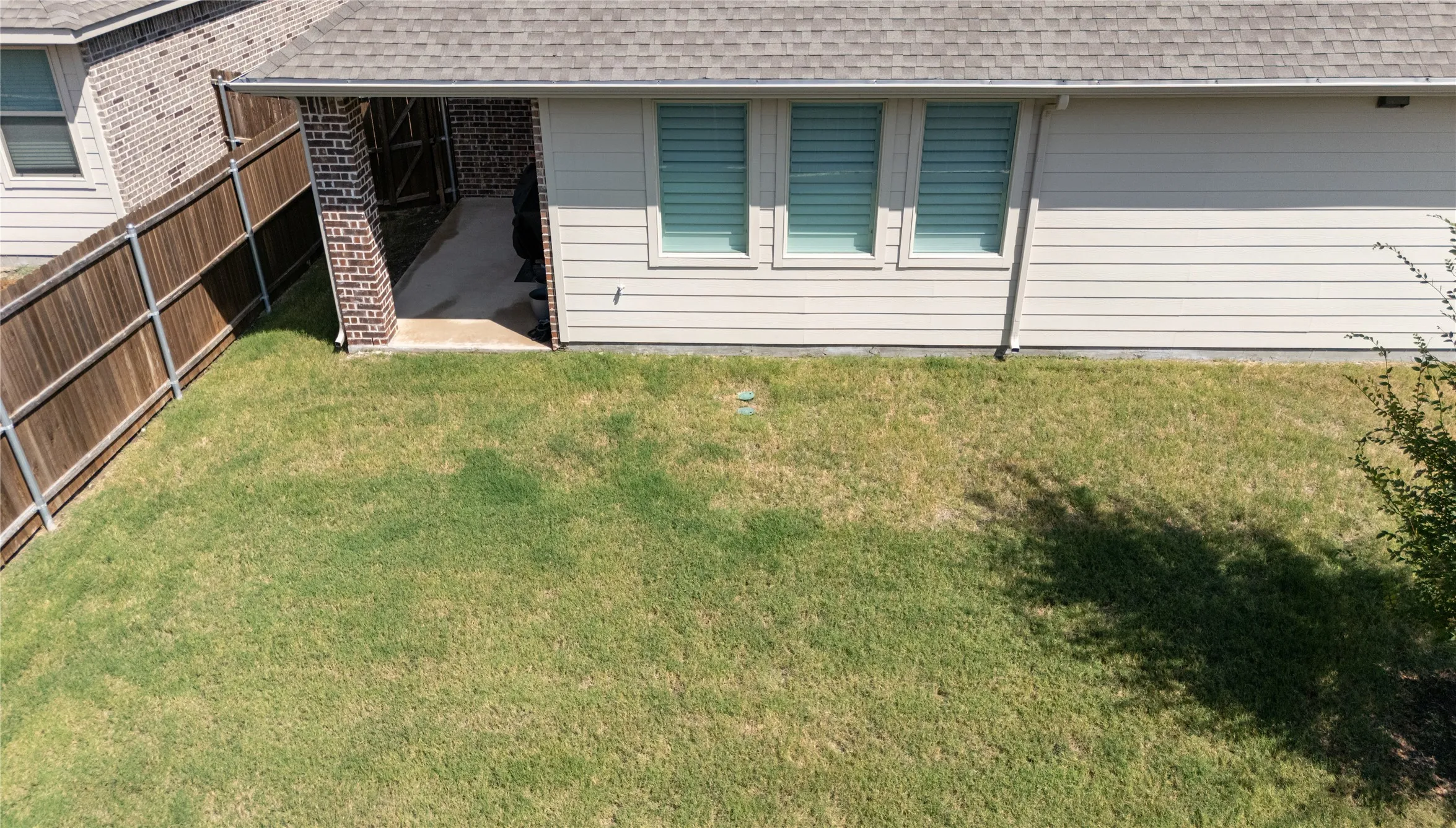 Expansive yard space with a wood privacy fence