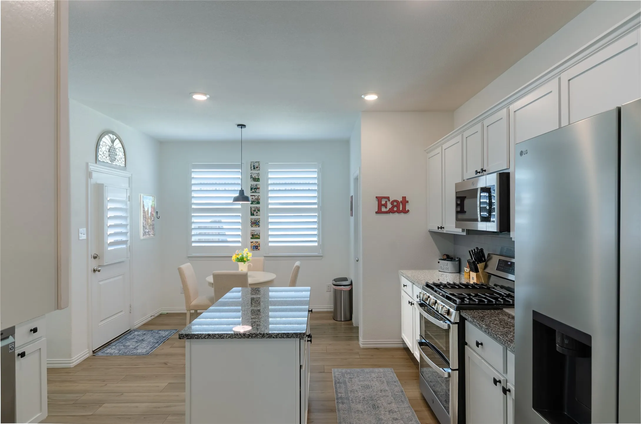 White walls featuring three windows with horizontal blinds