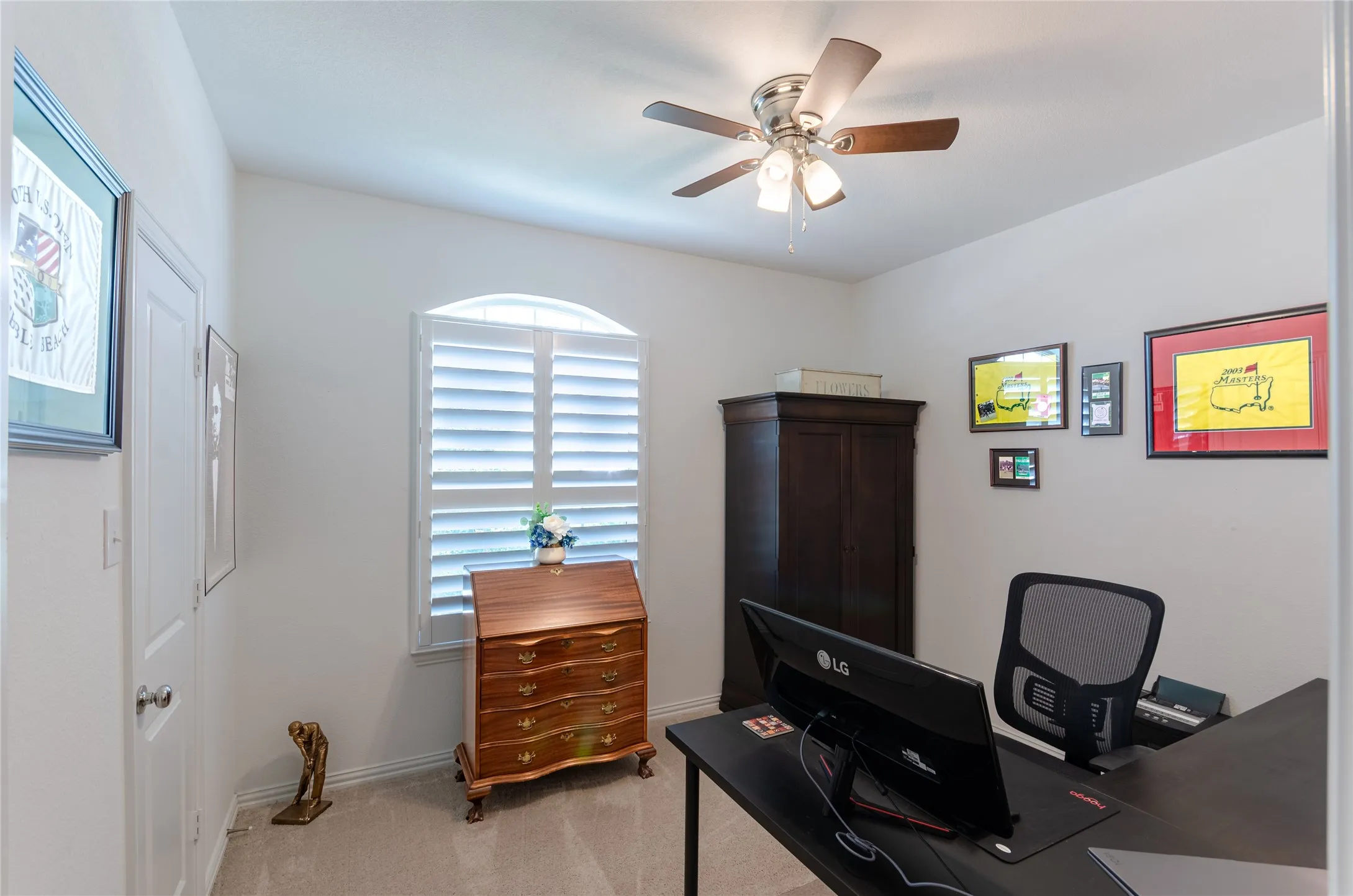 White shaker-style door with a transom window, plantation shutters, and a pendant light fixture