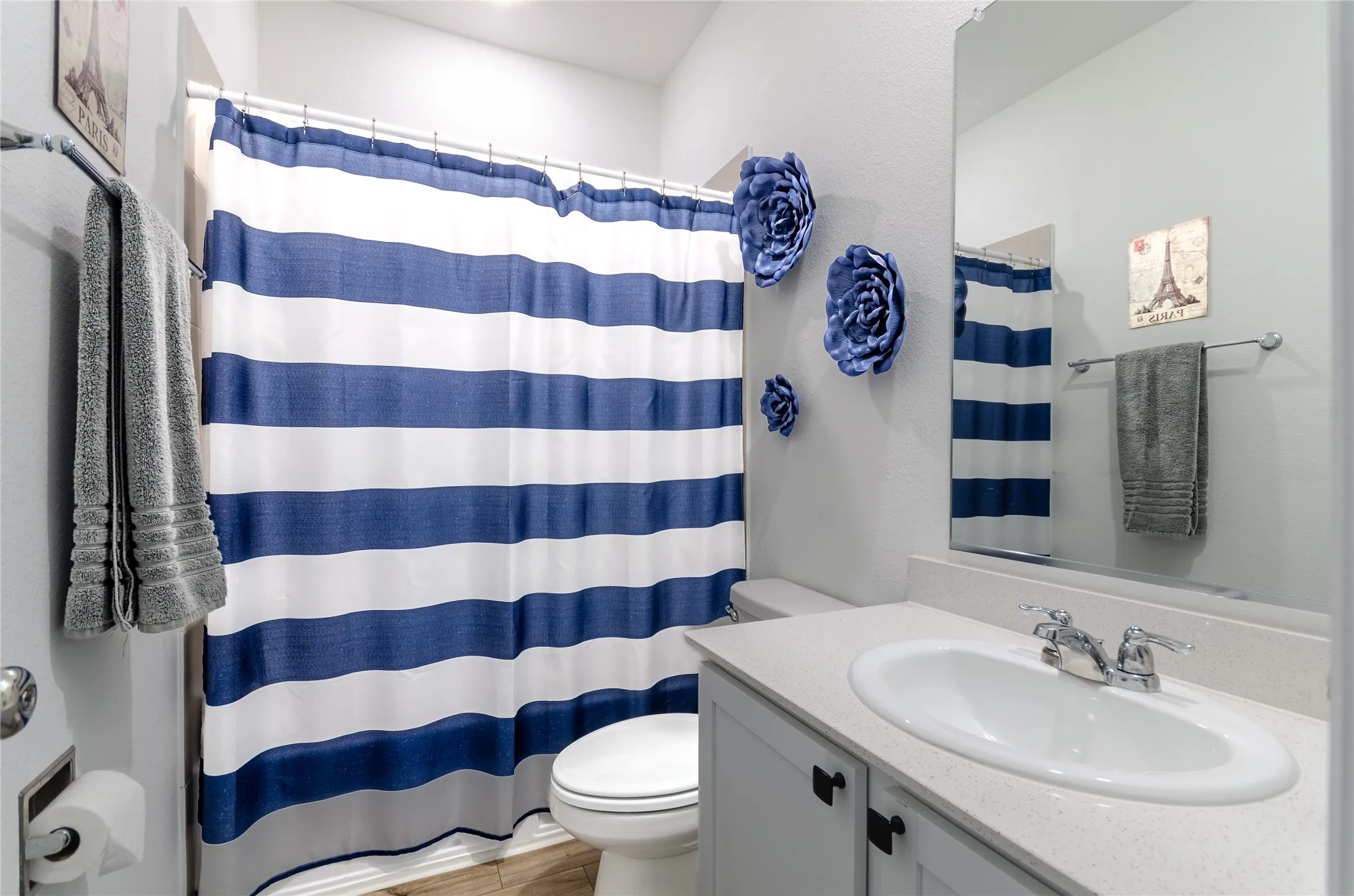 Recessed lighting with a ceiling fan, multiple windows with horizontal blinds, and wood-finish flooring