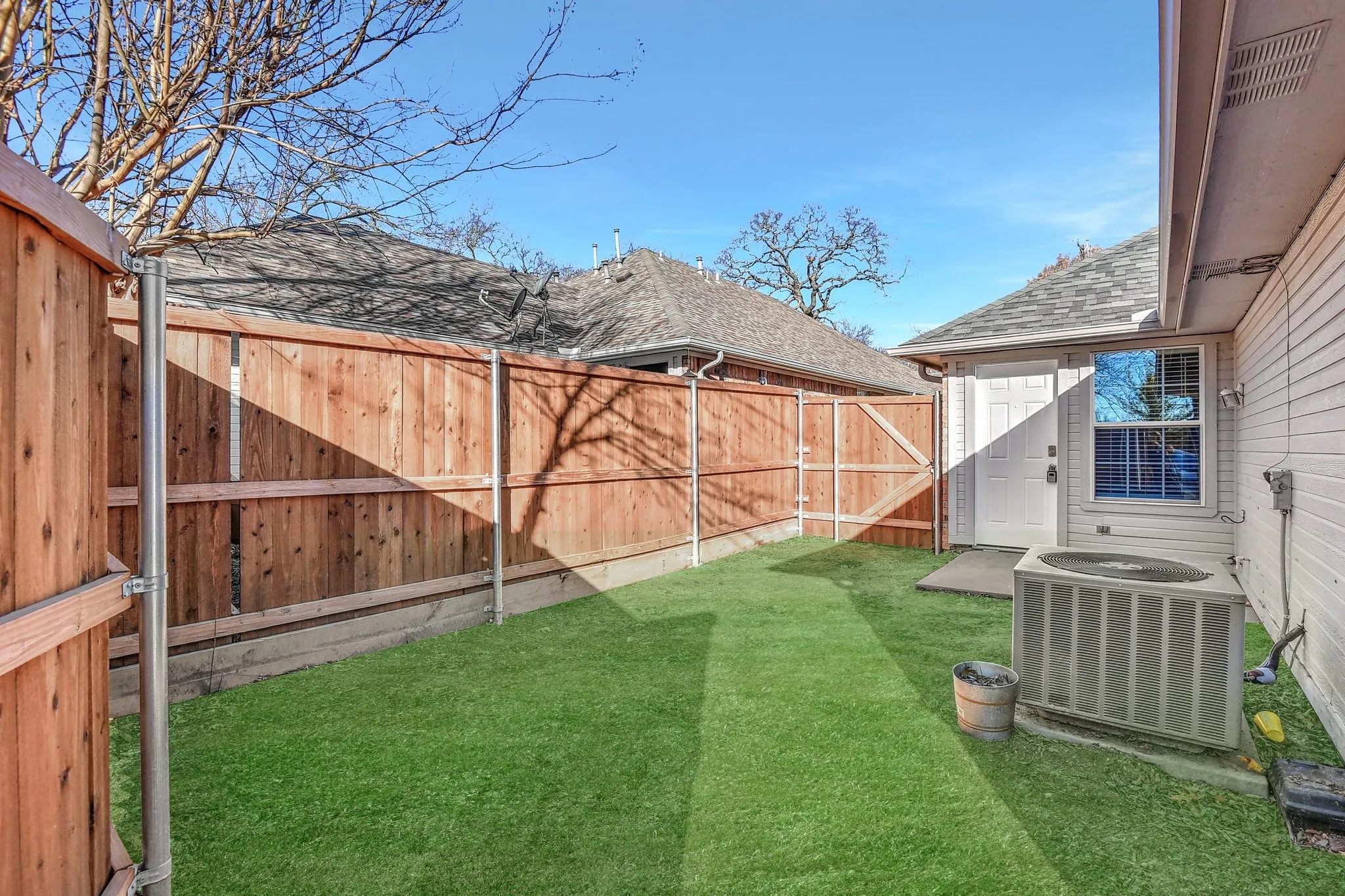 View of yard with cooling unit and a fenced backyard