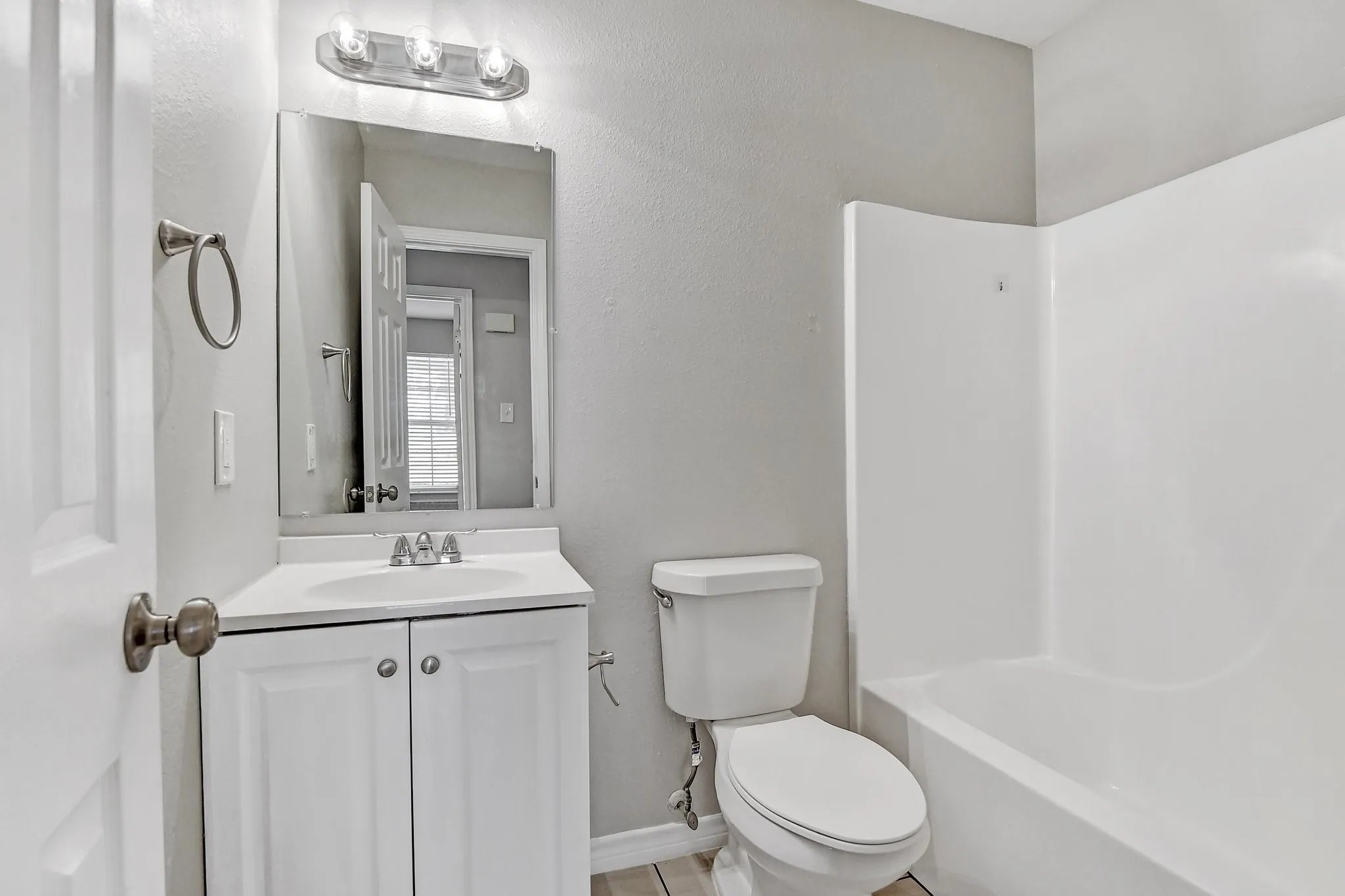 Full bathroom featuring vanity, baseboards, and toilet