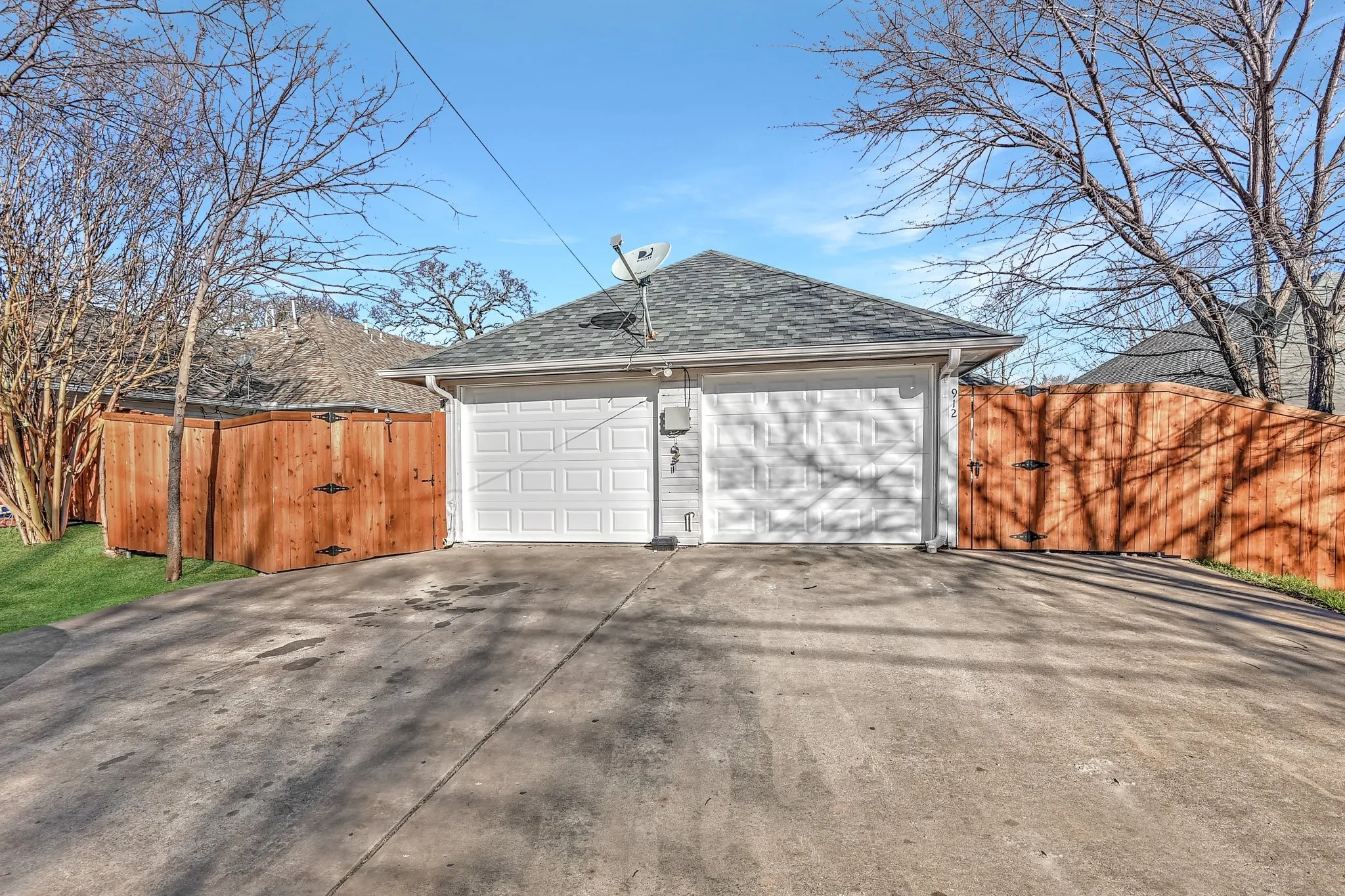 Detached garage featuring fence and a gate