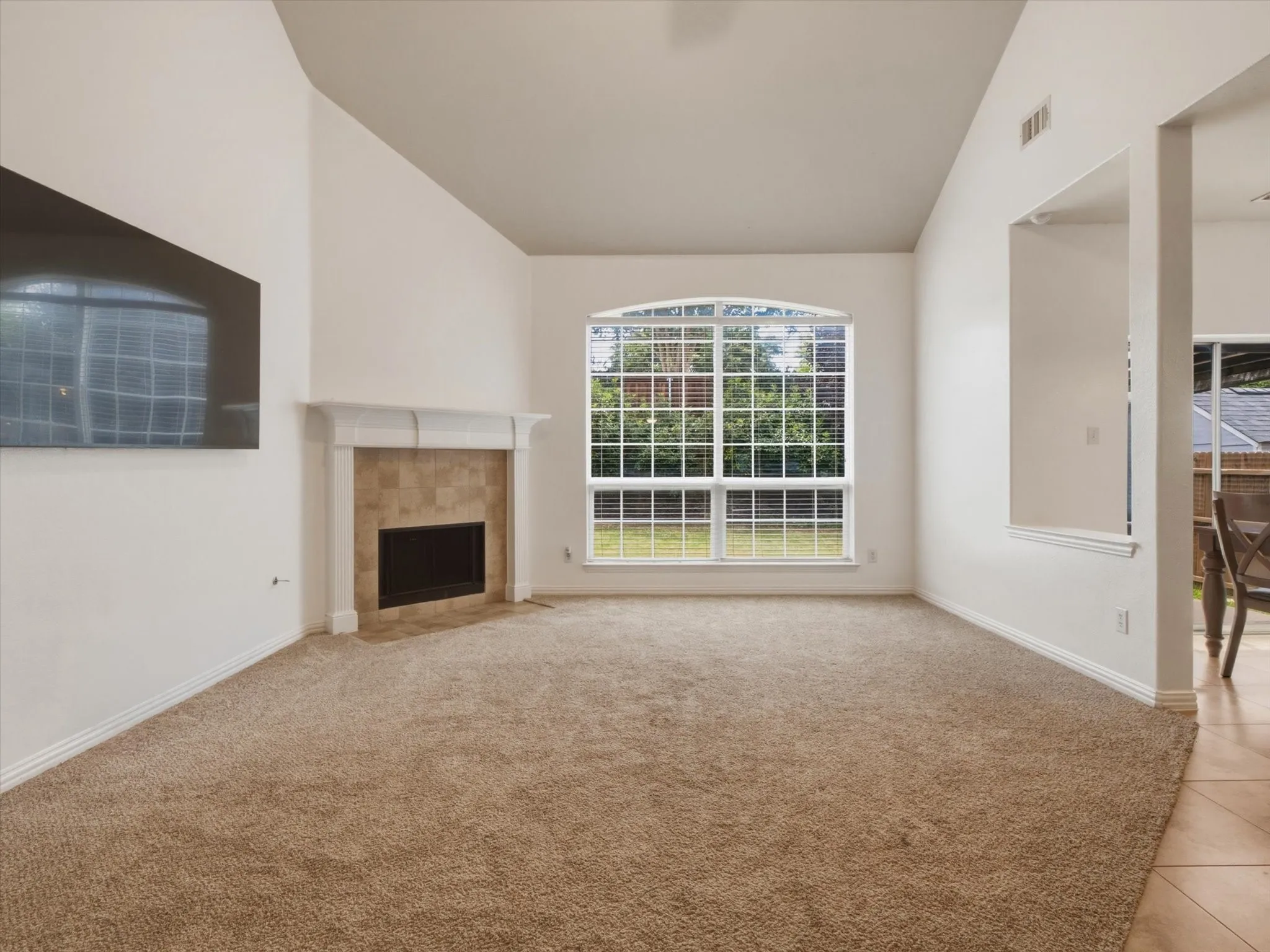 Living area with exterior views, vaulted ceiling