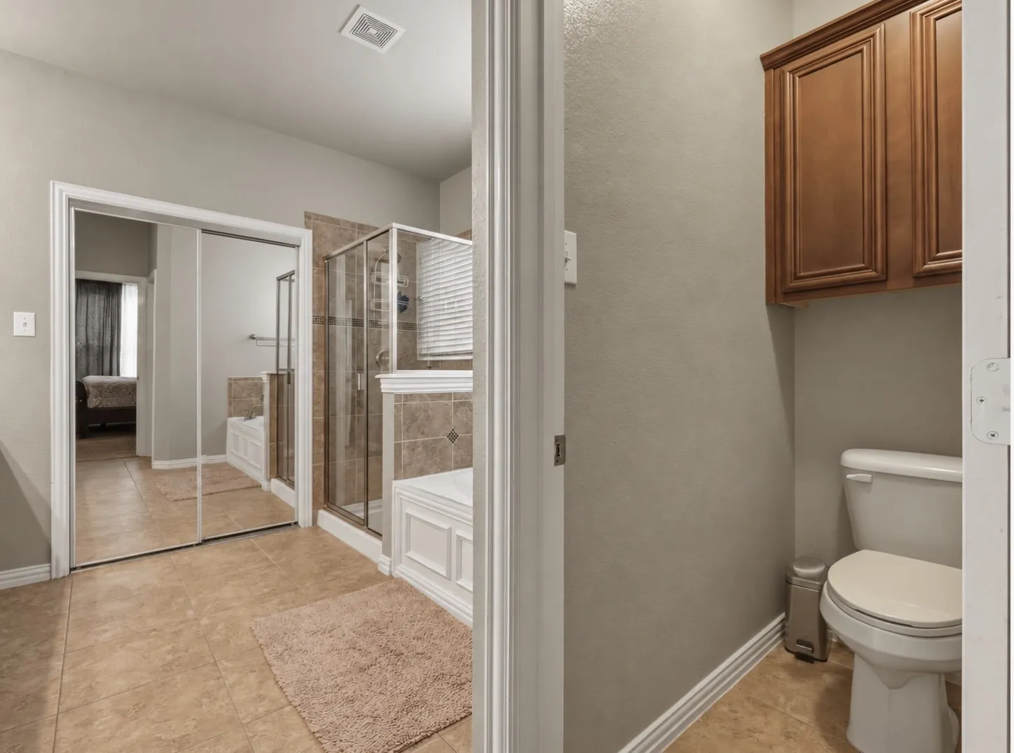 Walk-in shower with glass enclosure, separate soaking tub, and tile surround