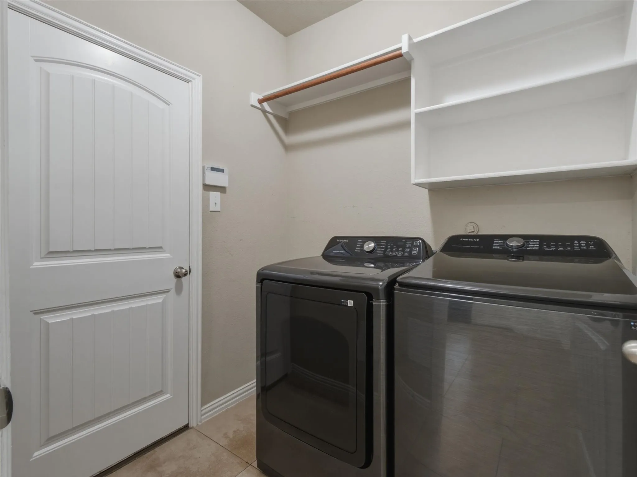  Built-in shelving with a hanging rod, tile flooring
