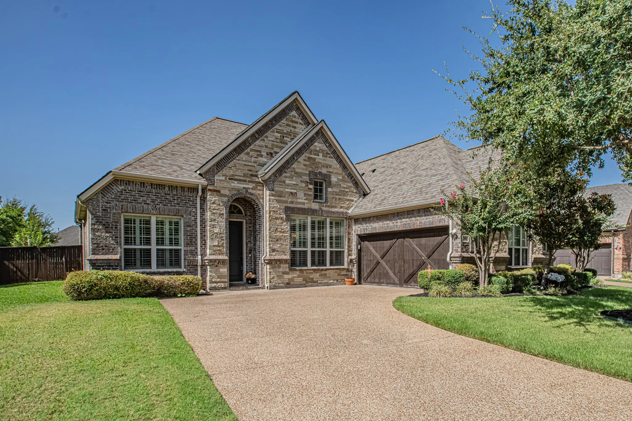 Stone and brick exterior with a gabled roofline