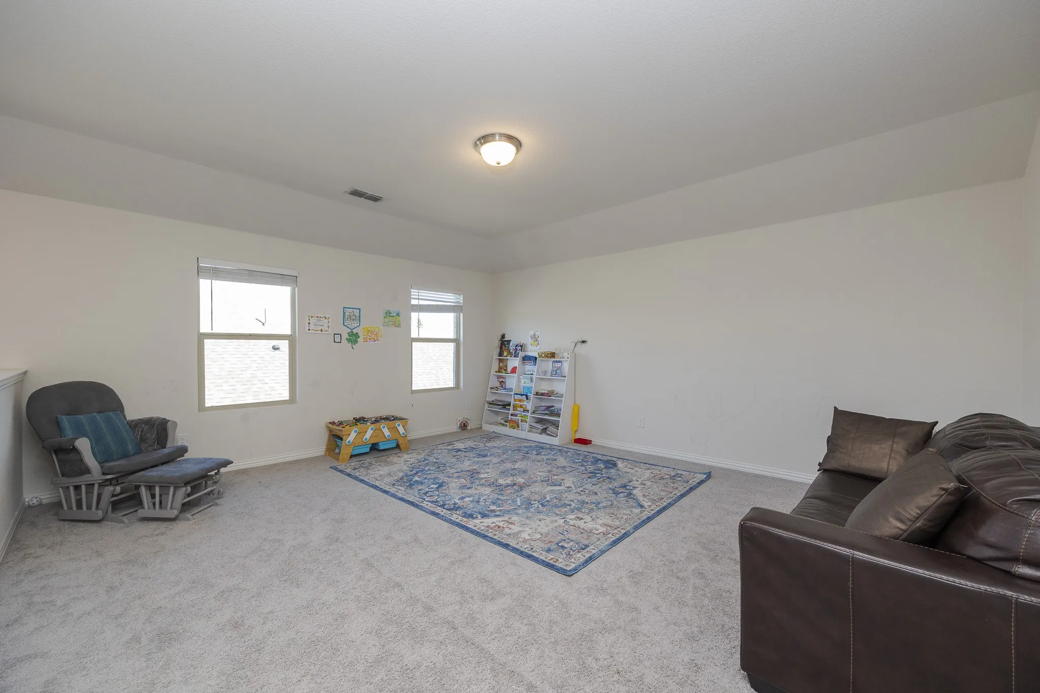 Neutral wall paint, recessed lighting, and carpeted flooring