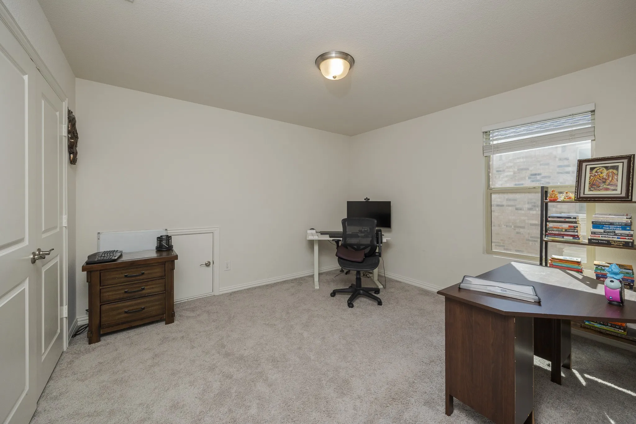 Wall-to-wall carpeting, window with blinds, and flush mount ceiling light