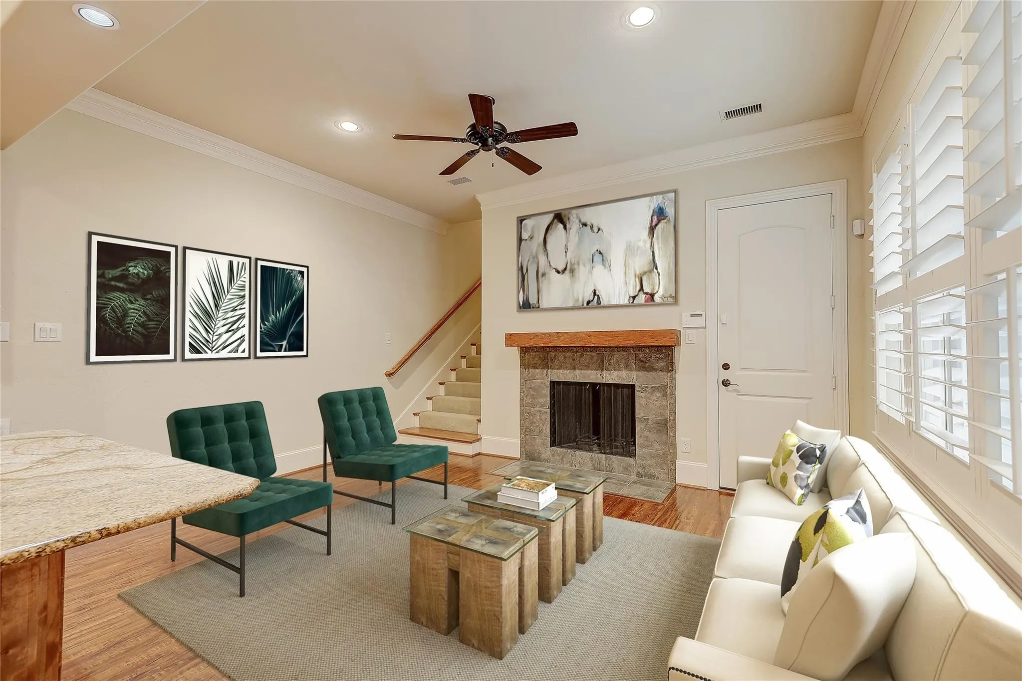 Living area featuring wood-finish flooring, a stone-surround fireplace with a wood mantle, white plantation shutters, a ceiling fan, and recessed lighting