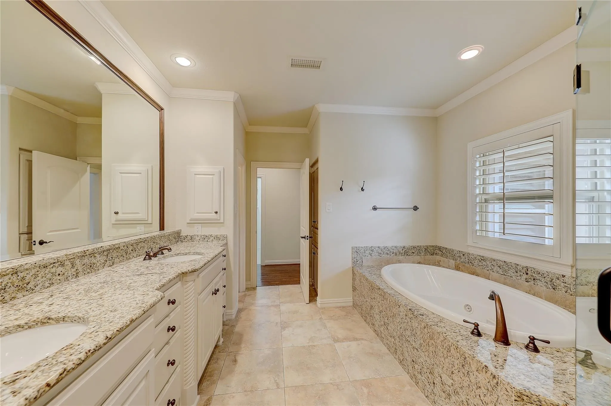 Dual vanity with stone countertops and undermount sinks