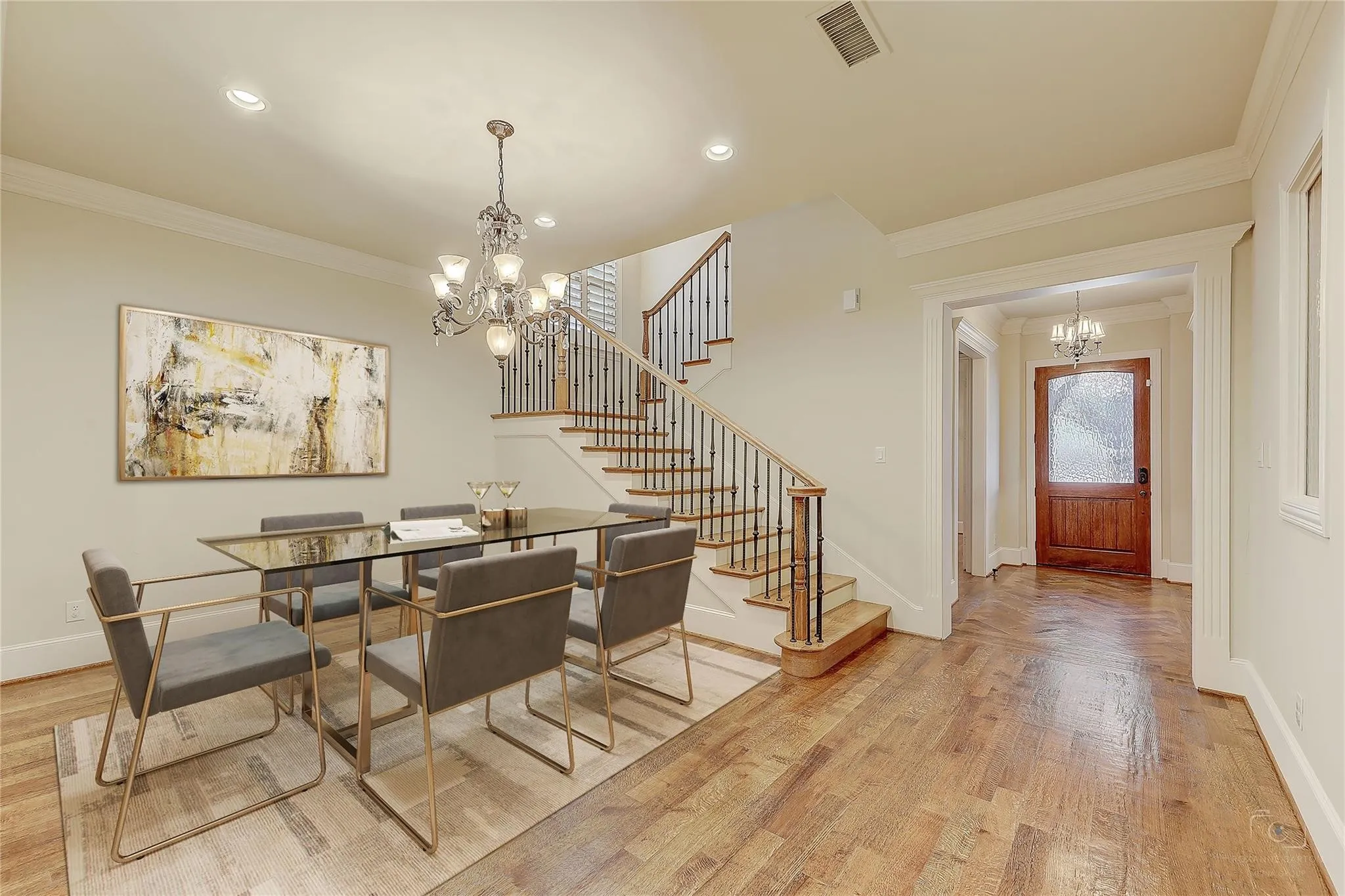 Hardwood flooring, elegant chandelier, built-in staircase with wrought iron balusters, recessed lighting, and a paneled entry door