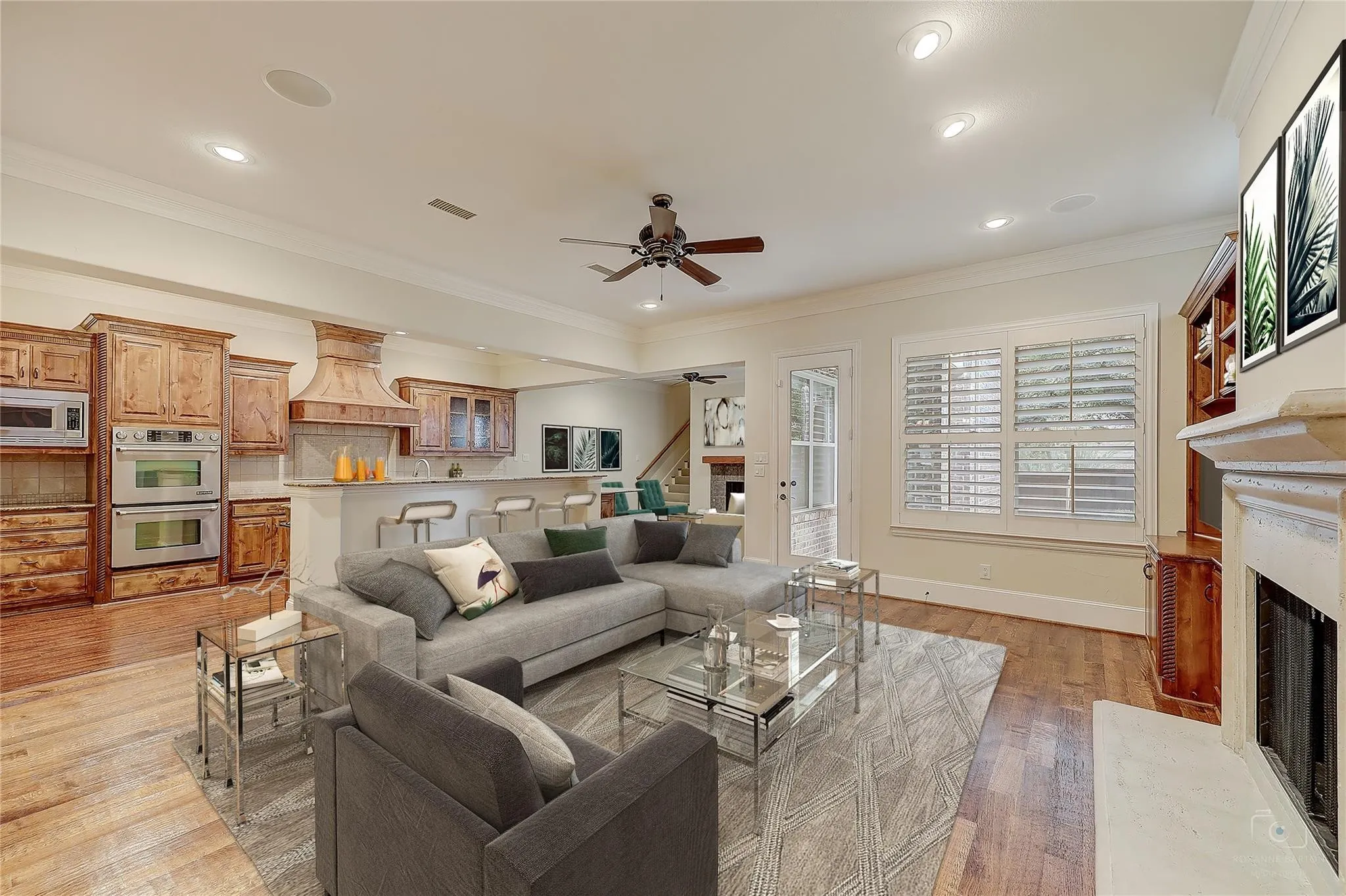 Living area featuring wood-finish flooring, recessed lighting, and a built-in fireplace