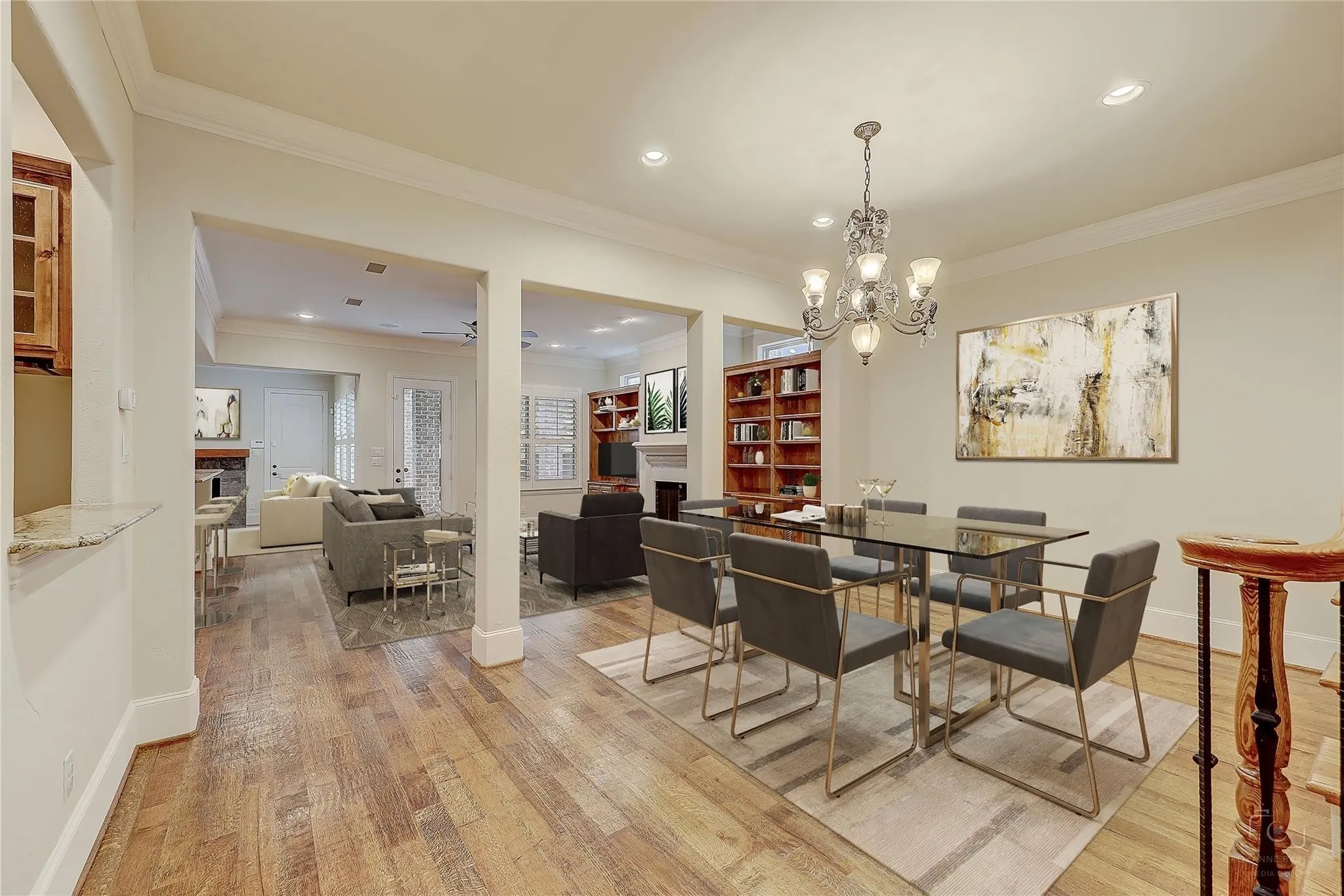 Wood-finish flooring throughout, recessed lighting, crown molding, and an elegant chandelier