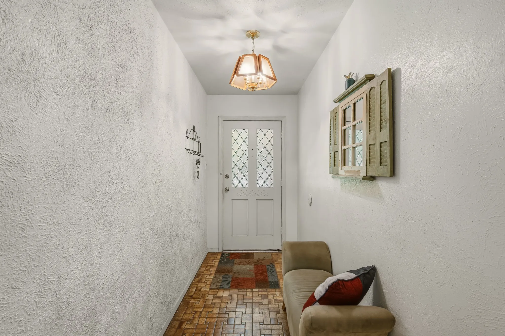 A pretty wood and glass door welcomes each visitor.