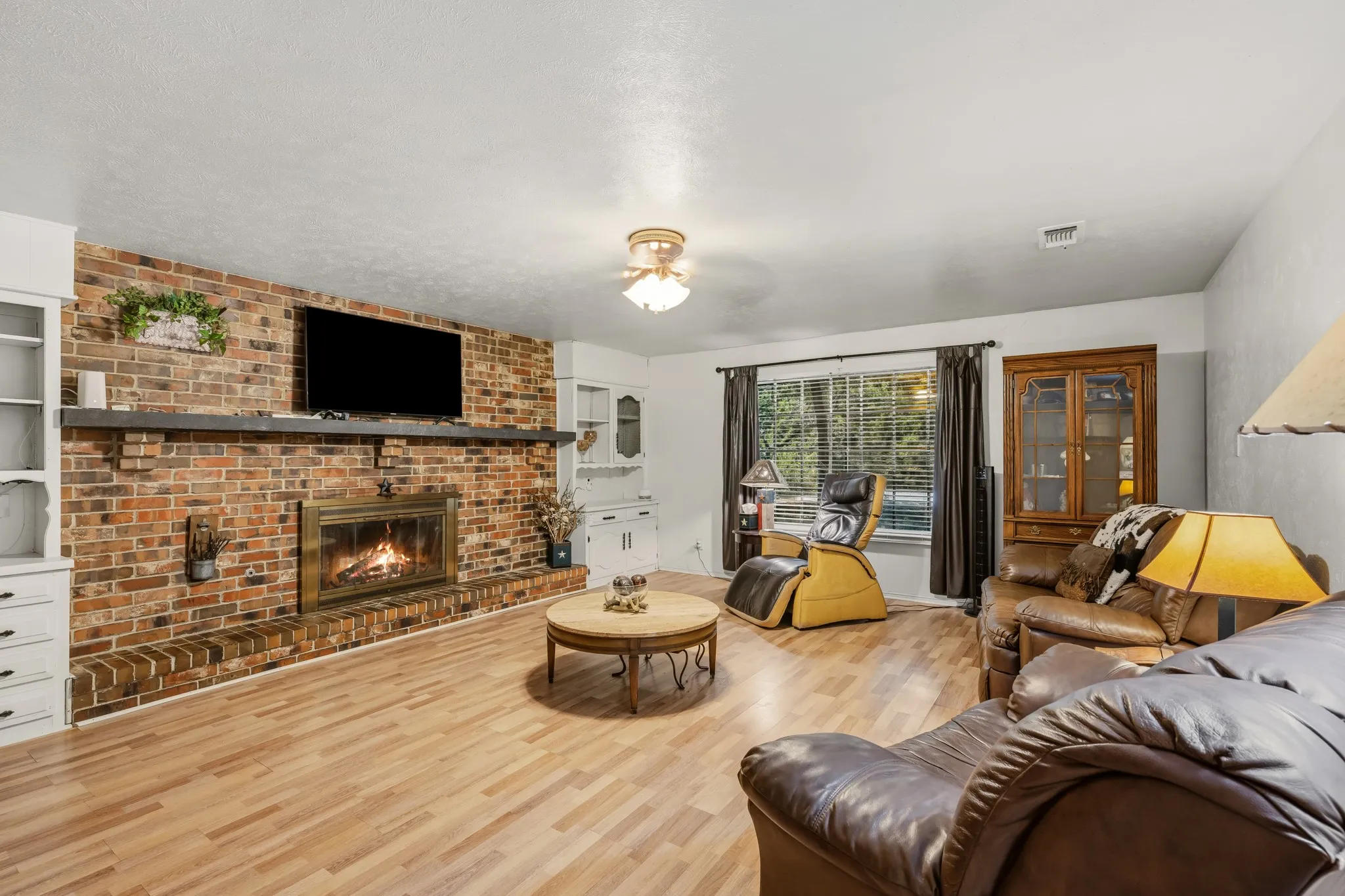 A cozy wood-burning fireplace warms the house on cold winter days.