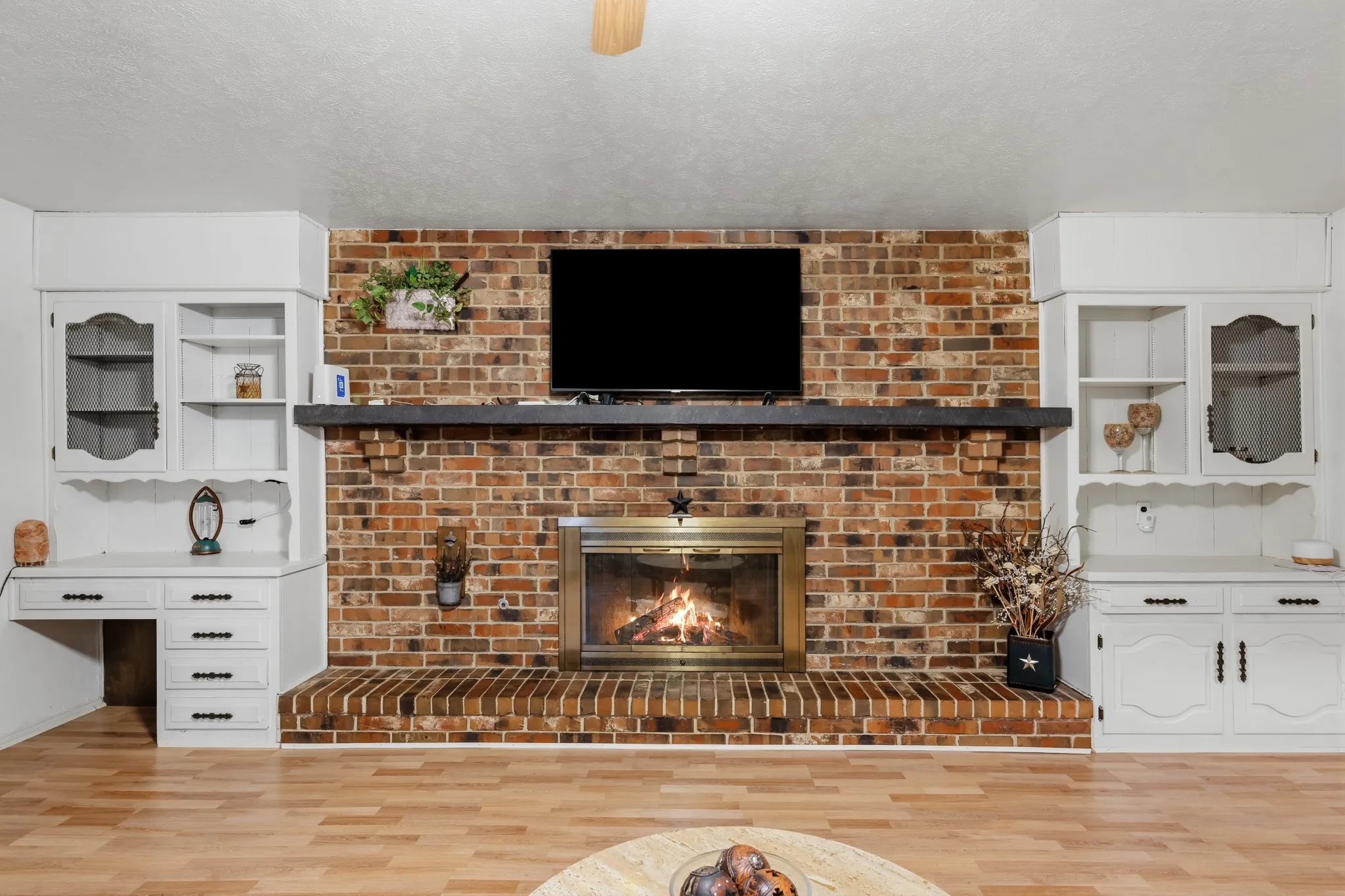 Great storage is on each side of the fireplace.