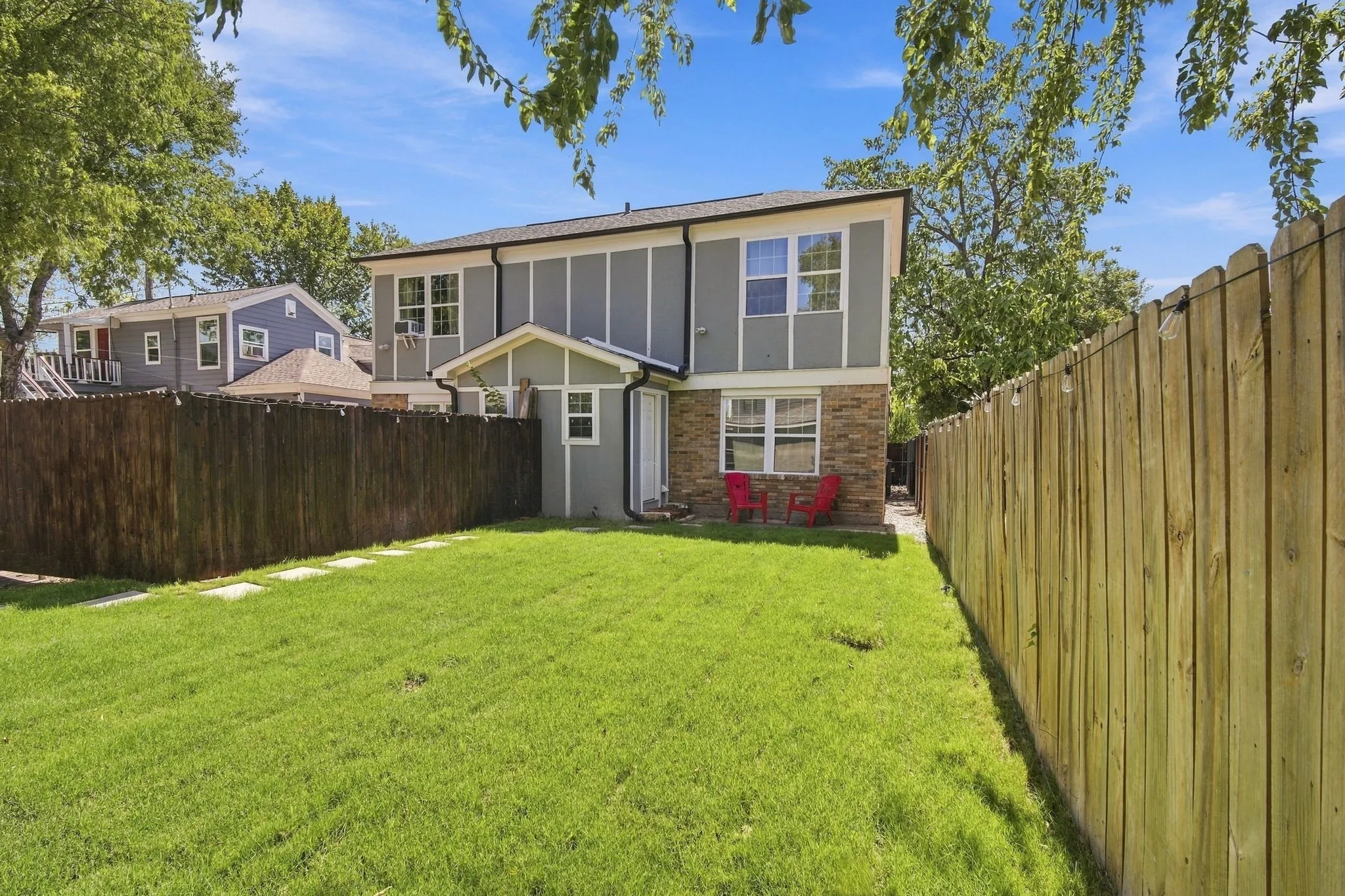 Large back yard with string lights