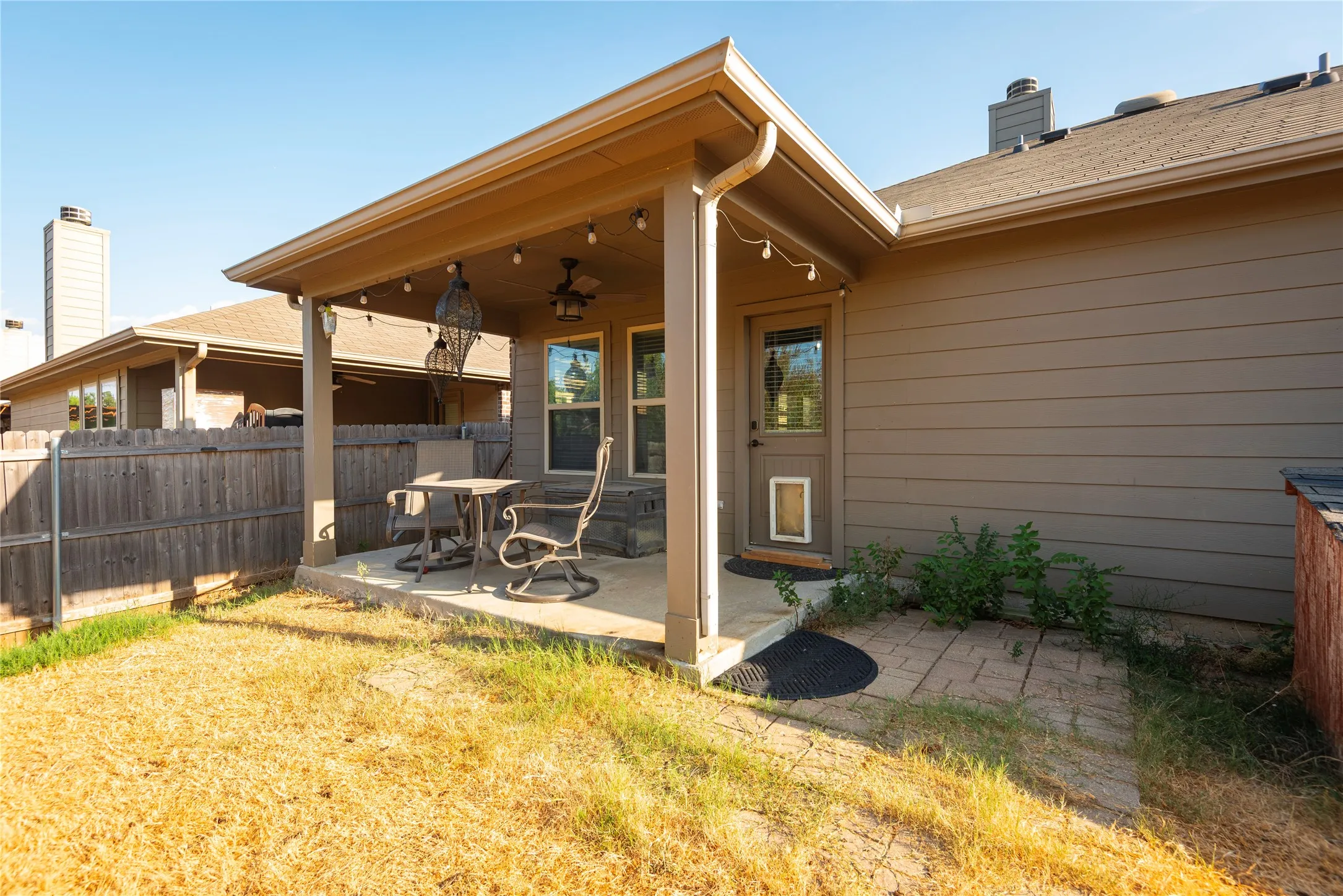 Covered patio with concrete flooring, supported by columns, and featuring recessed lighting