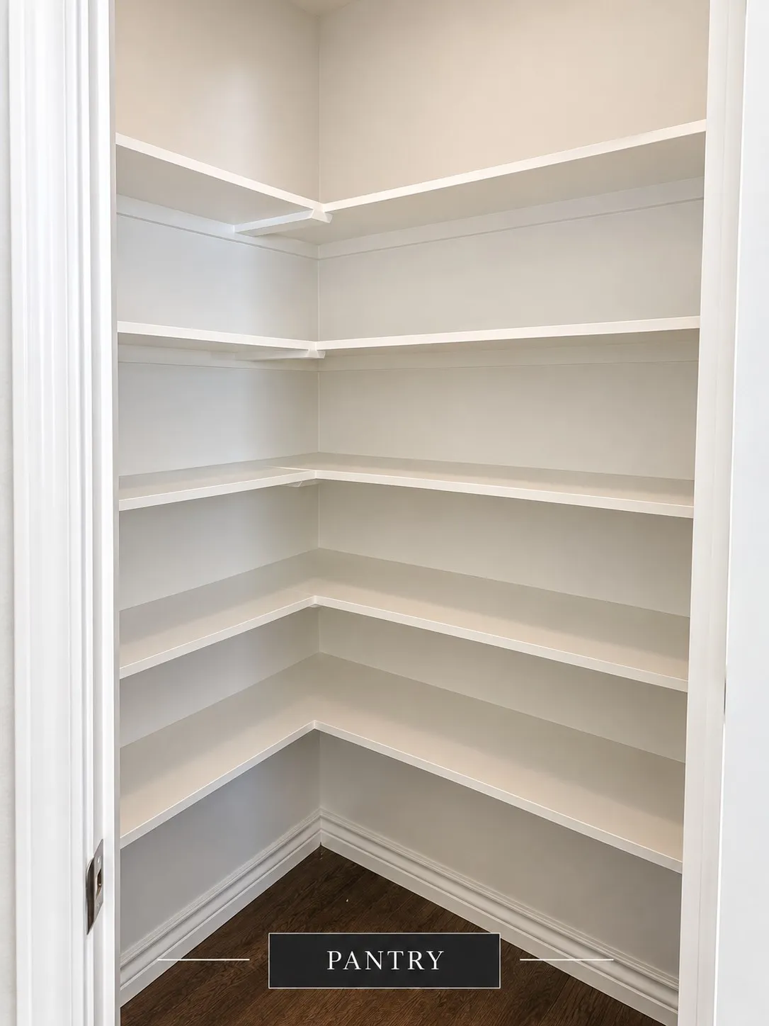 Corner pantry with ample shelving and wood-finish flooring