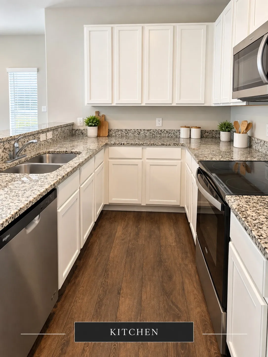U-shaped kitchen featuring white cabinetry, stone countertops, stainless steel appliances, a double basin sink, and wood-finish flooring
