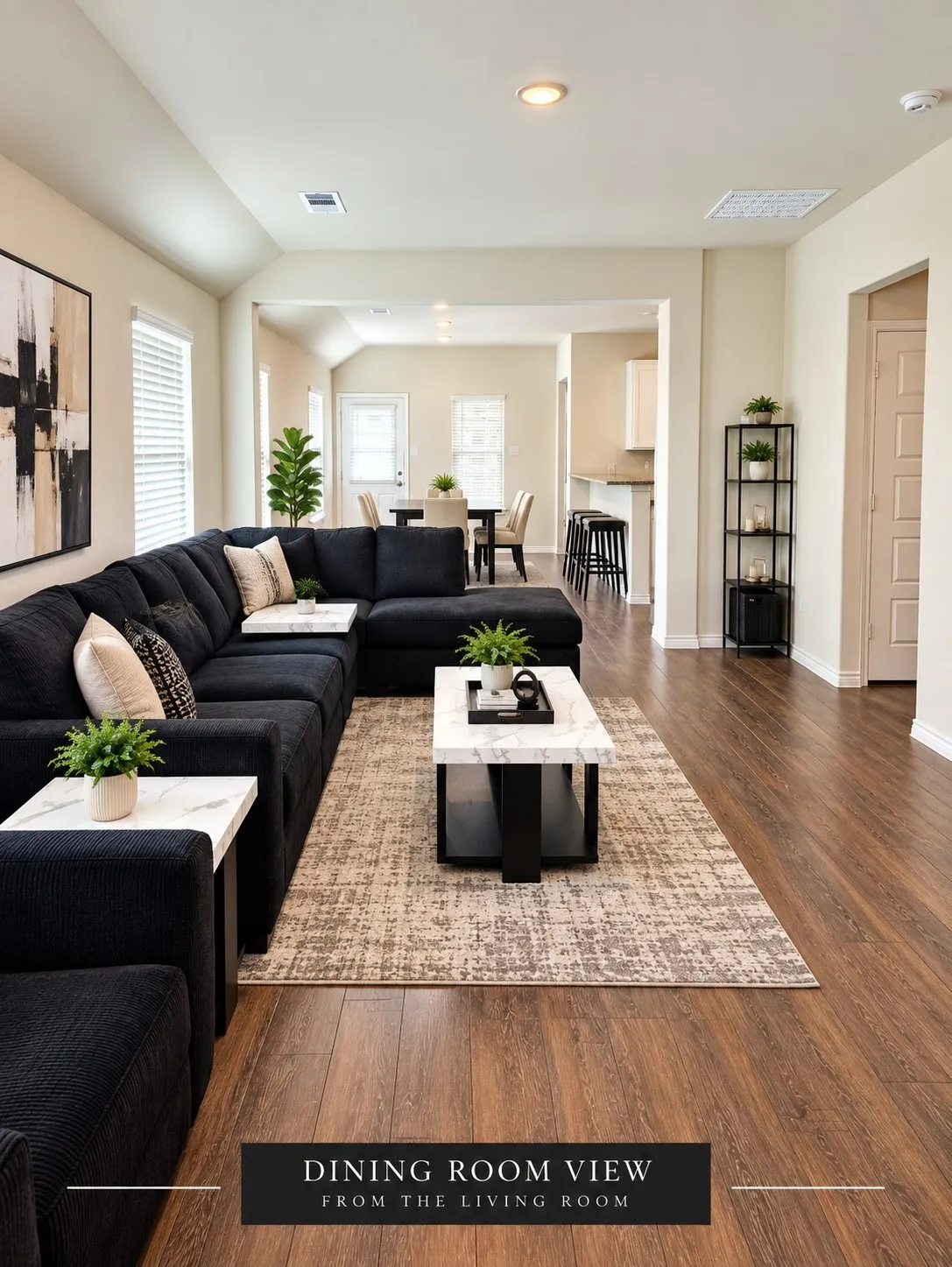Front Door View -Open-concept living area with wood-finish flooring, recessed lighting, and white trim