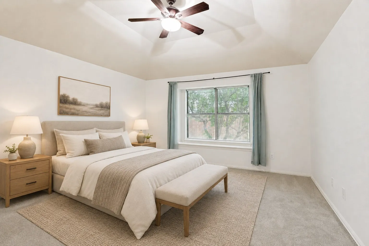 Tray ceiling with a built-in ceiling fan, window with exterior foliage, and neutral wall tones