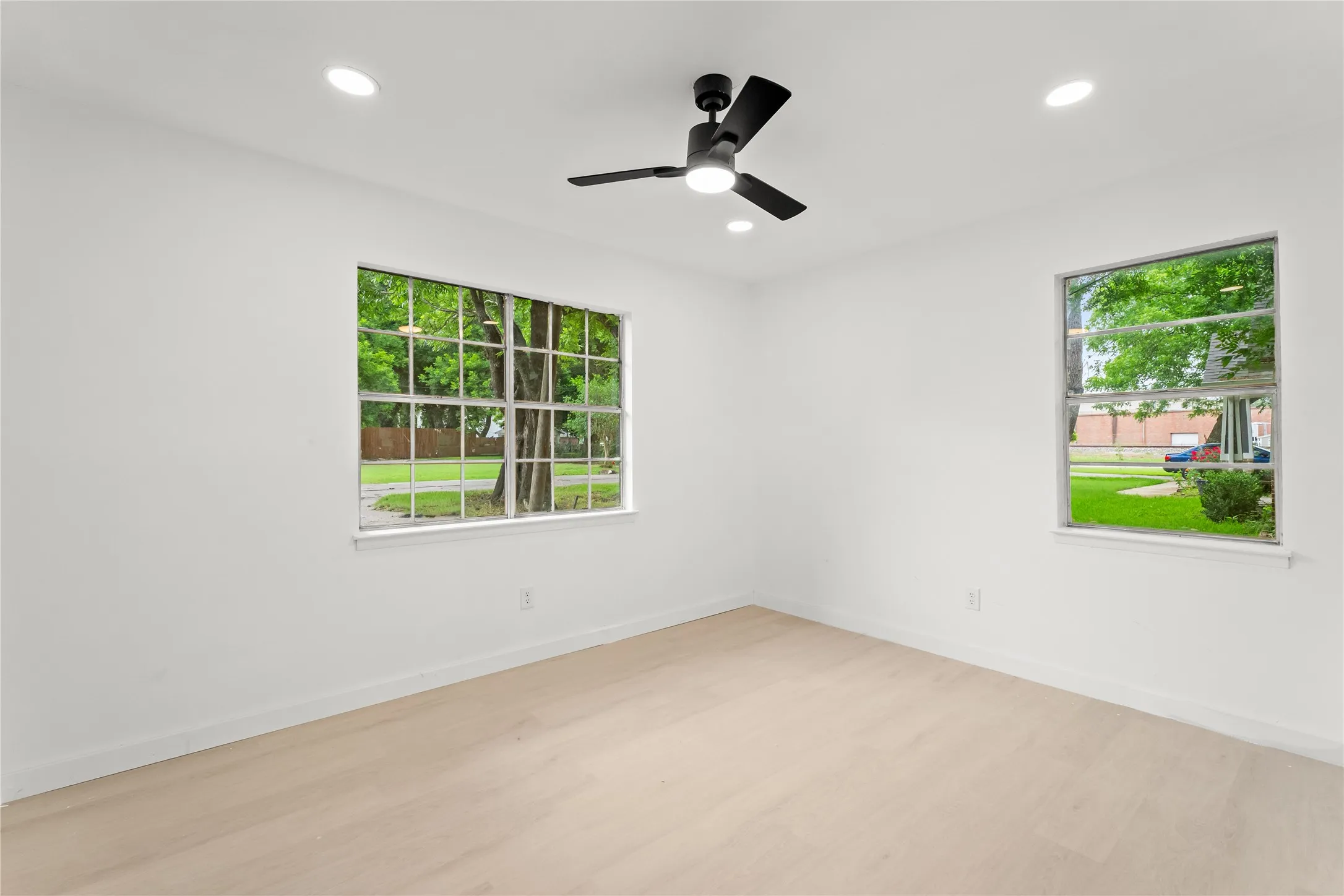Recessed lighting, ceiling fan, wood-finish flooring, and multiple windows