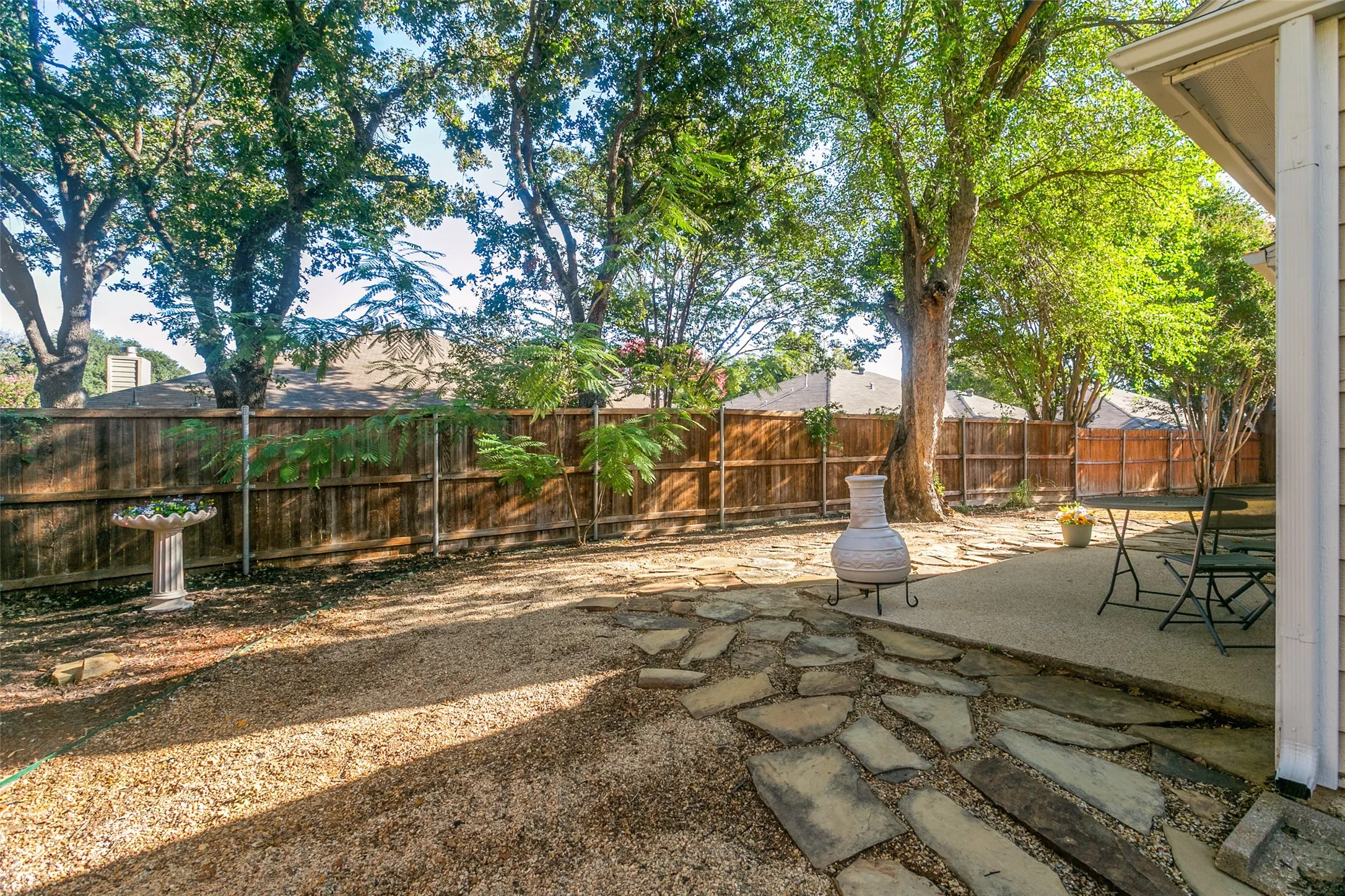 This backyard is extremely large, serene and very private. With Crepe Myrtles, a Mimosa Tree and others, this beautiful backyard has plenty of room for relaxing and entertaining.