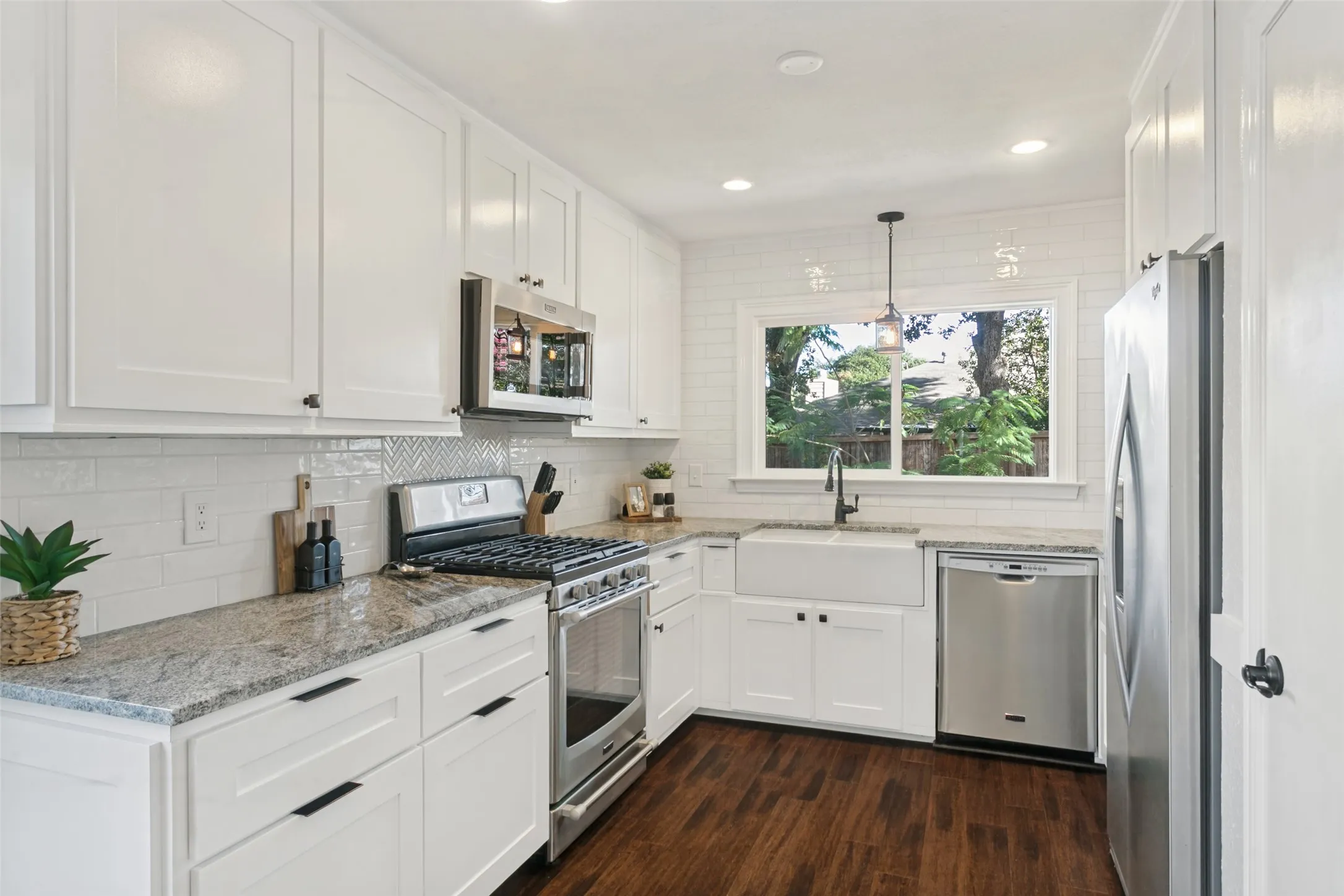 Kitchen is equipped with a farm style sink, granite countertops and soft close shaker style cabinets and pantry.