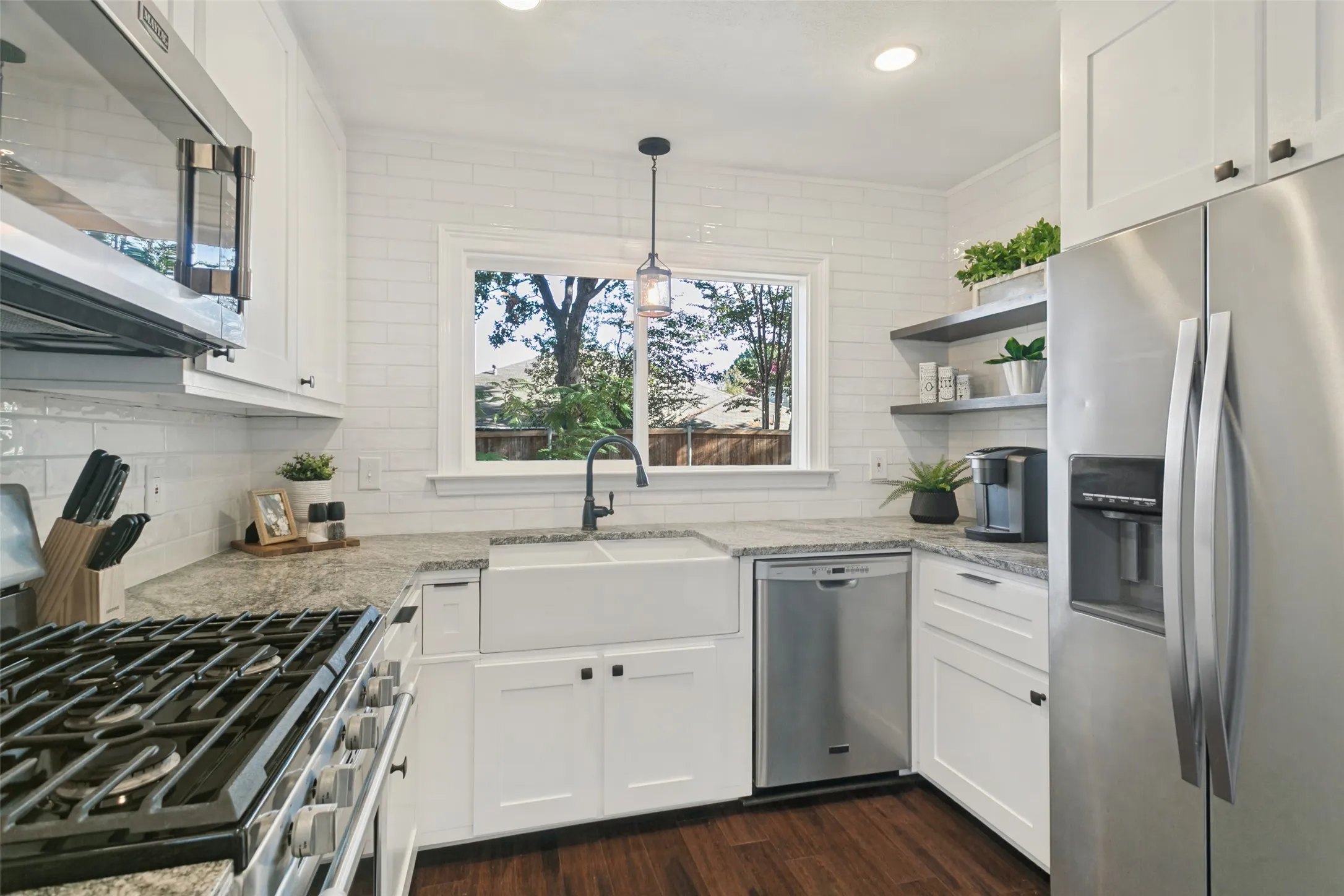 Chef's dream kitchen with gas stove, custom tile work throughout kitchen area with an abundance of cabinet space.