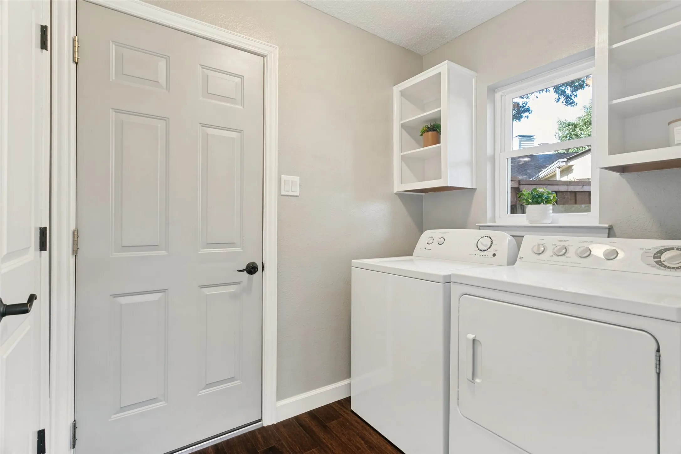 The laundry room off kitchen is spacious and has an additional nice sized storage closet.