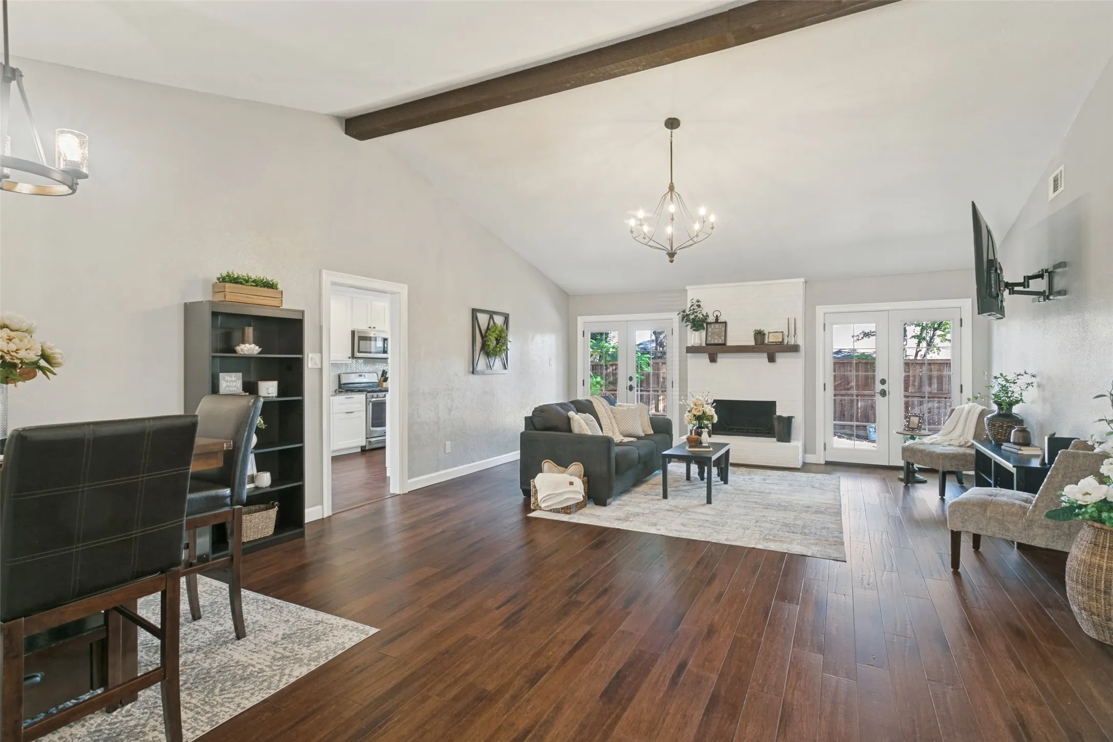 Upon entry, you will find the open living and dining areas with vaulted ceilings.