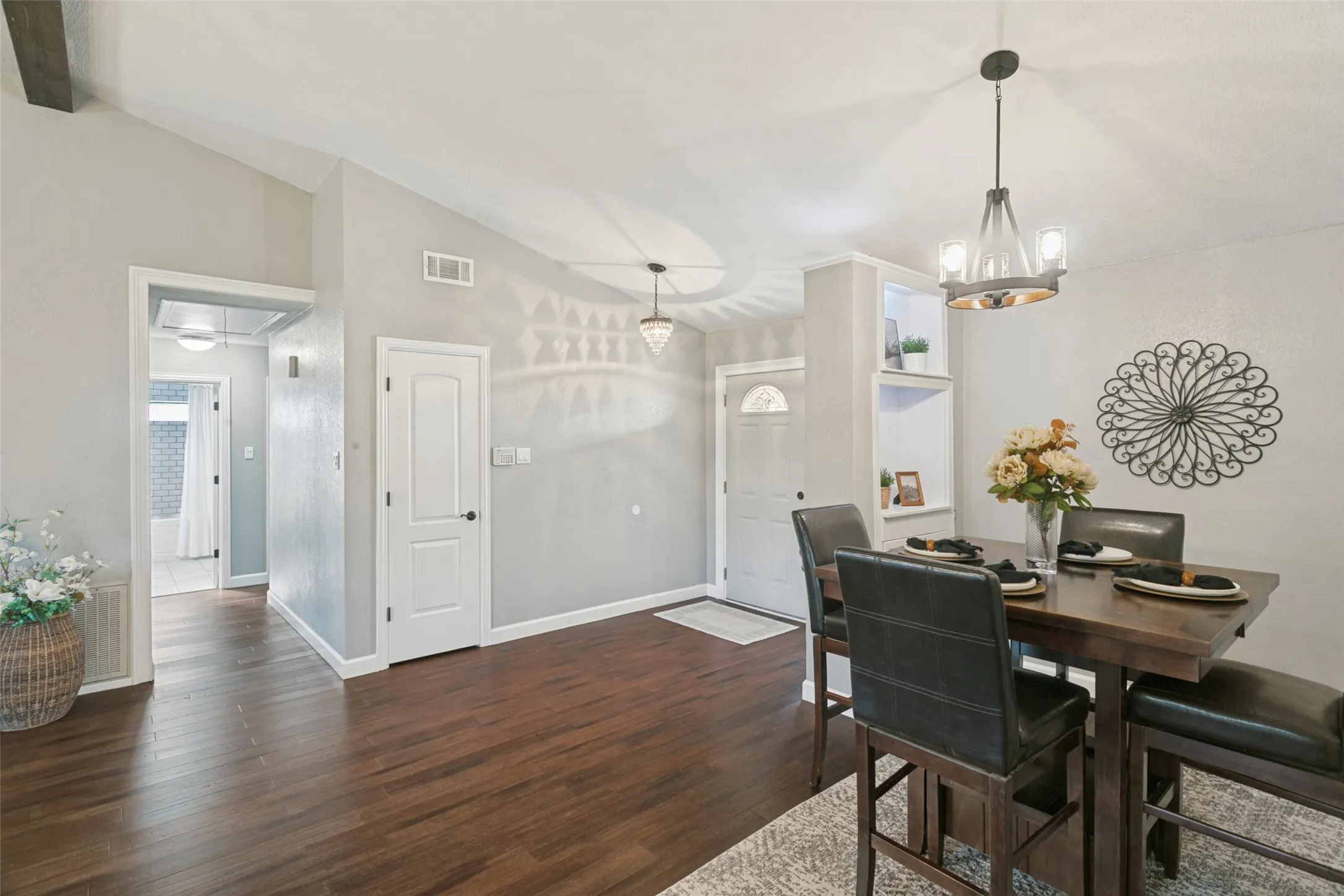 Formal dining area has a lighted bar area with cabinets for additional storage.