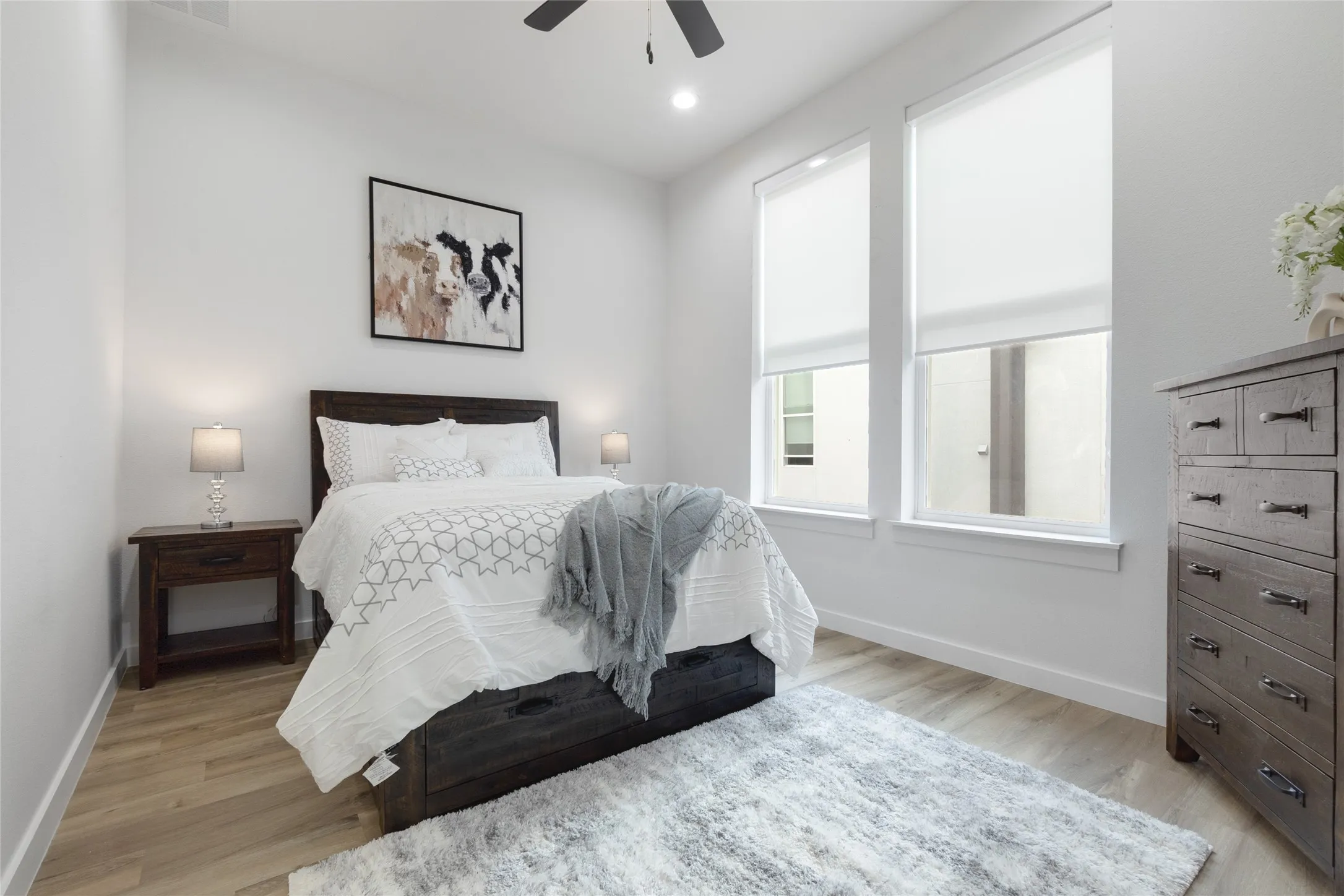 Wood-finish flooring, recessed lighting, and a ceiling fan